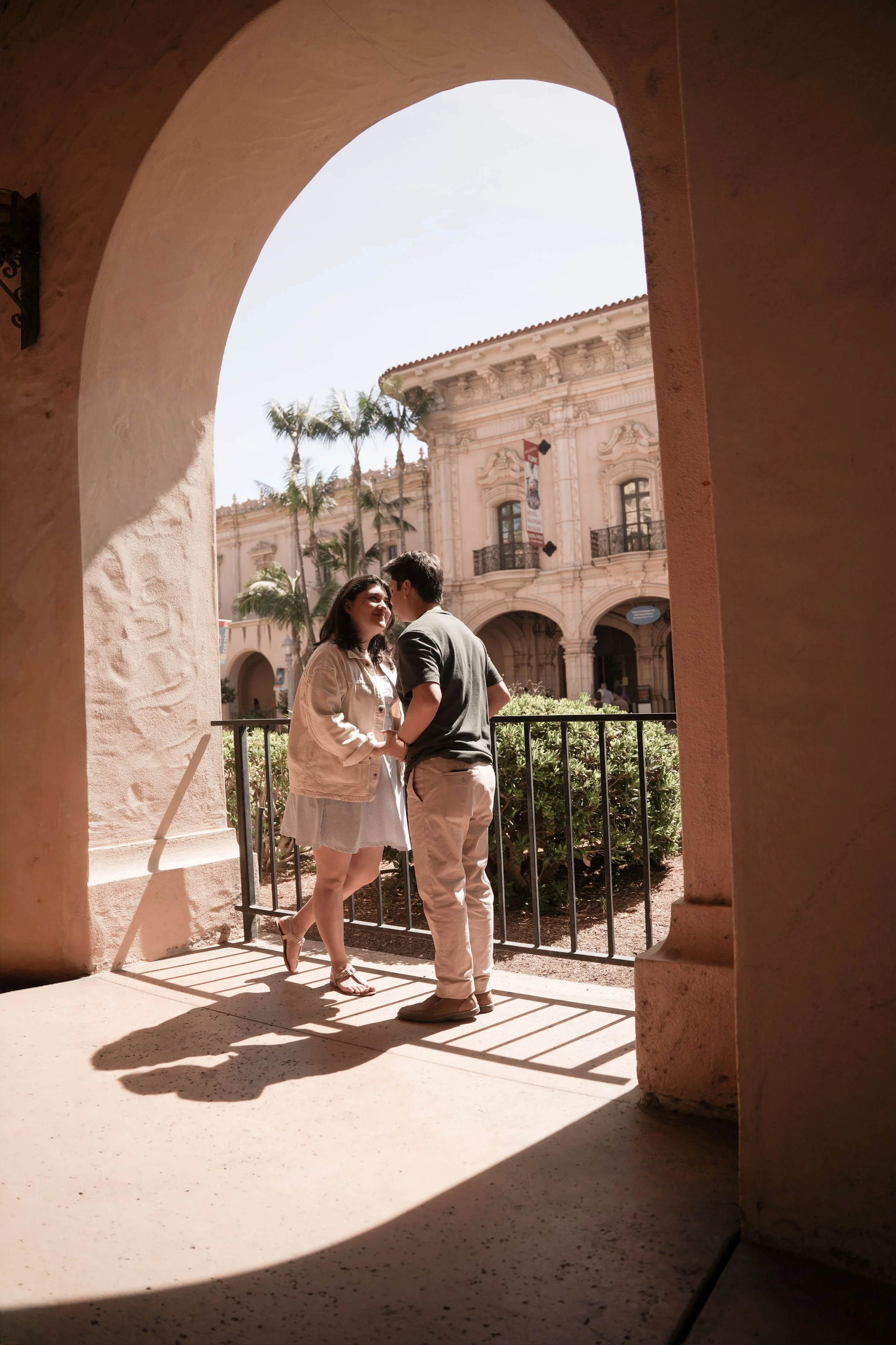 Engaged couple posing for engagement photos at Balboa Park