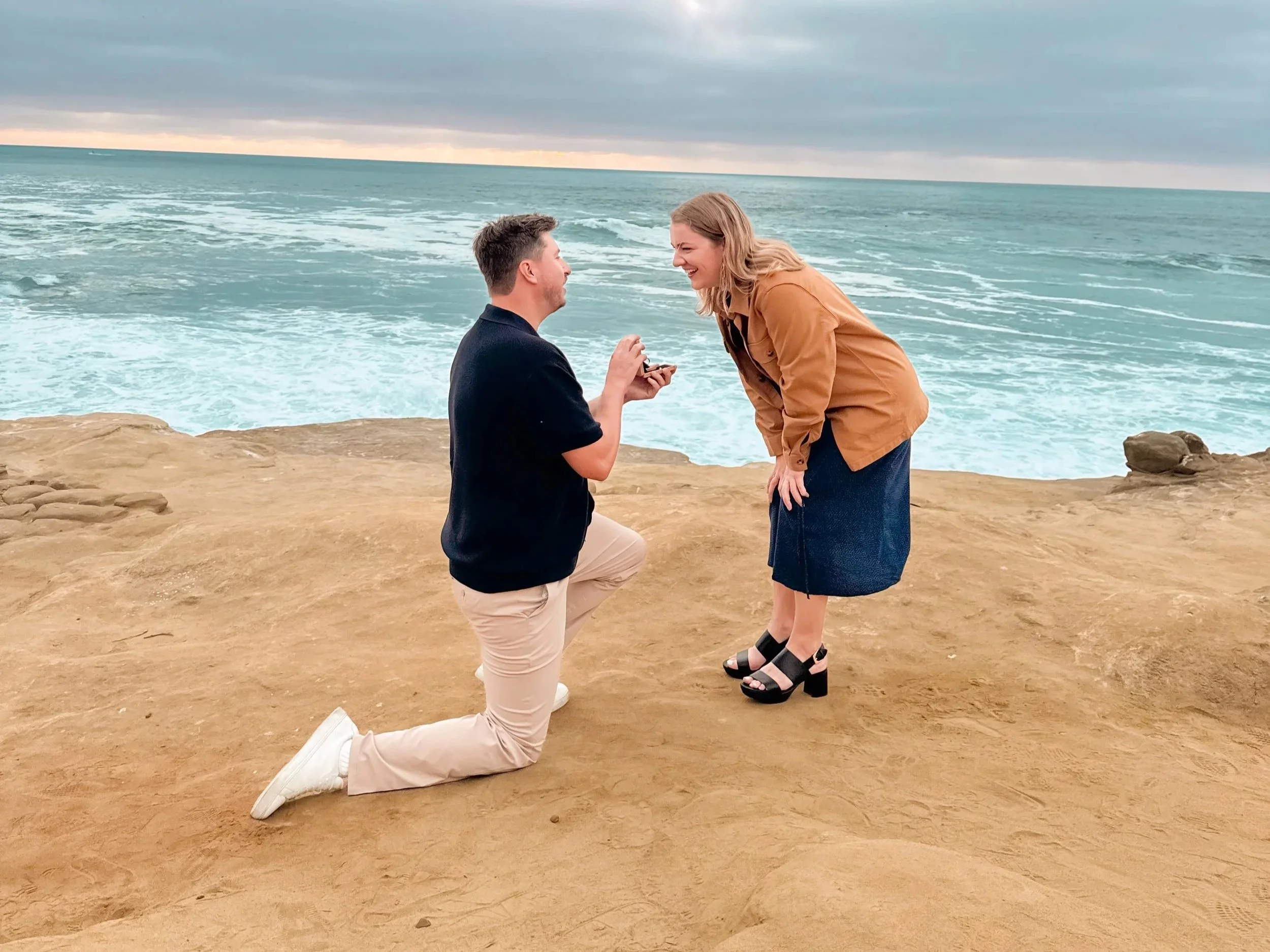 Brett proposing to Mary Bray at Seal Rock near Scripps Park in La Jolla Cove, captured on an iPhone after the professional camera failed.