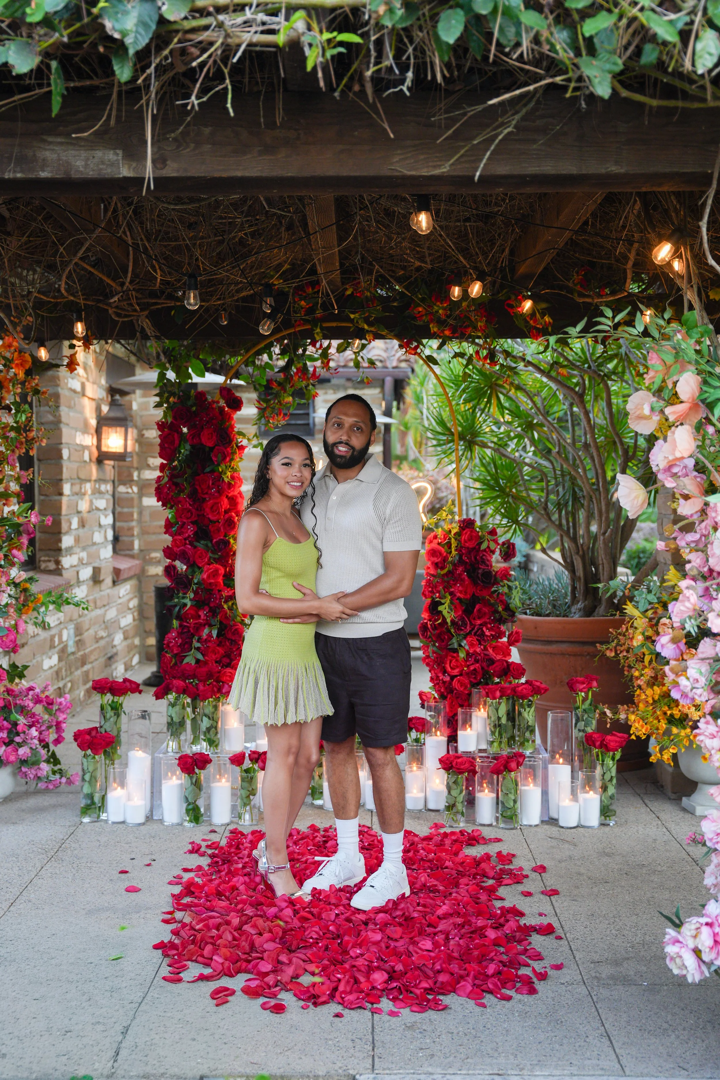 Destination surprise proposal at Estancia La Jolla Hotel &amp; Spa featuring a couple celebrating their engagement.