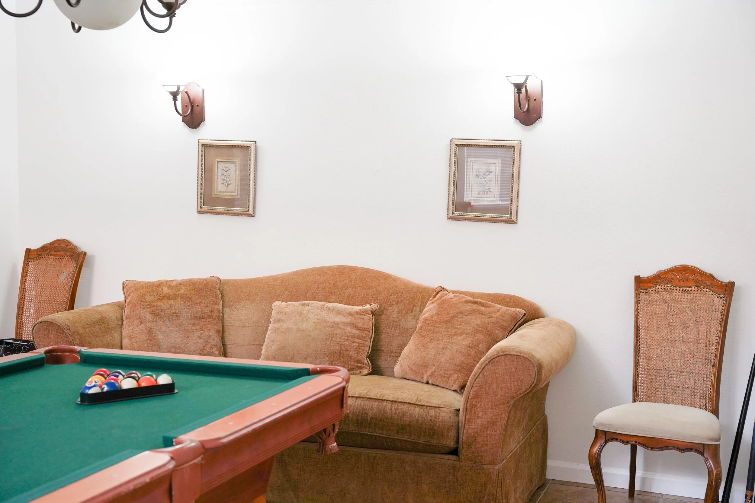 Interior real estate photo of spacious game room staged for Airbnb guests.