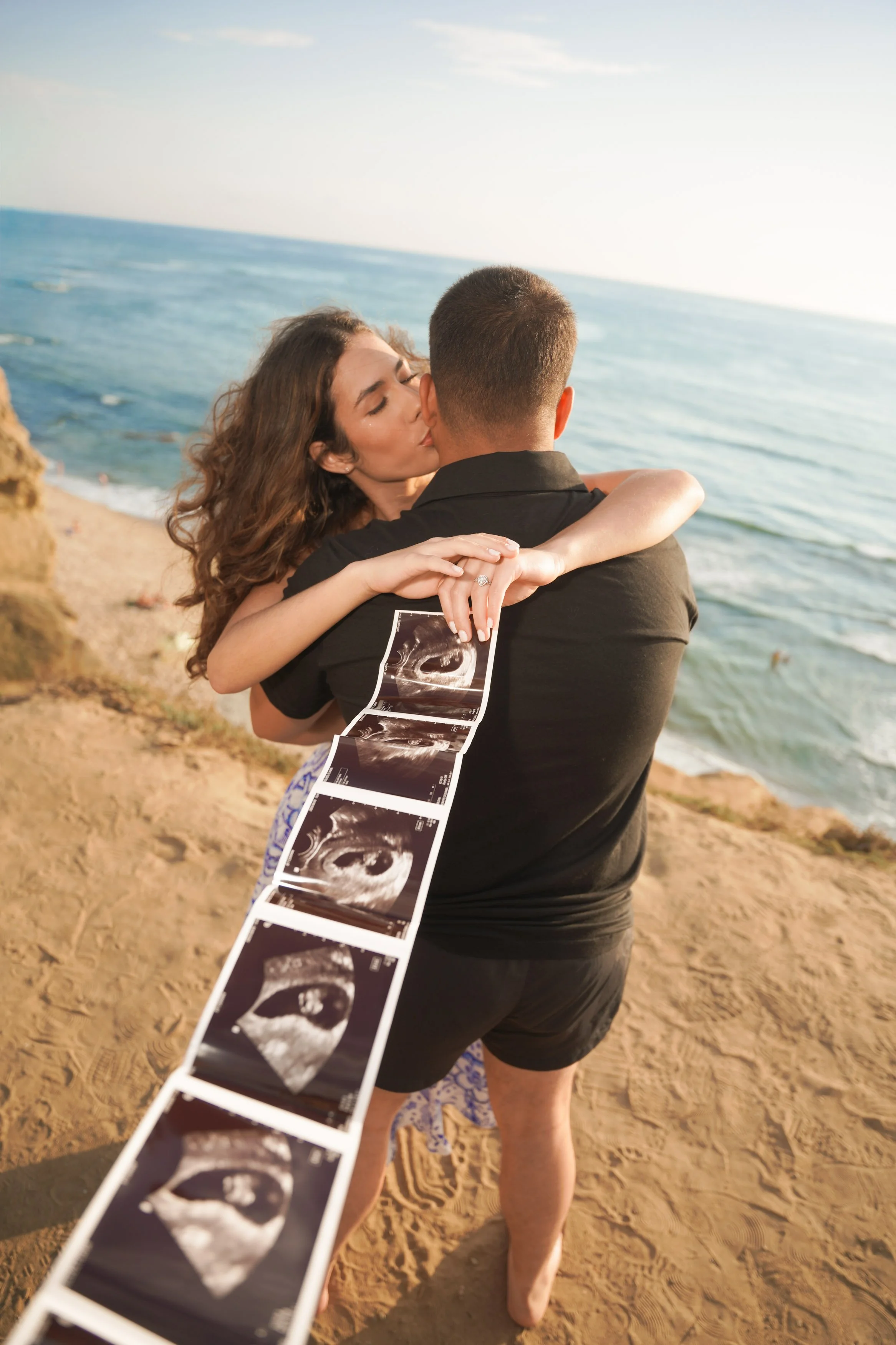 San Diego pregnancy reveal photography at Sunset Cliffs with dramatic skies, golden coastal landscapes, and timeless romantic light, secure your unforgettable baby announcement portraits today.