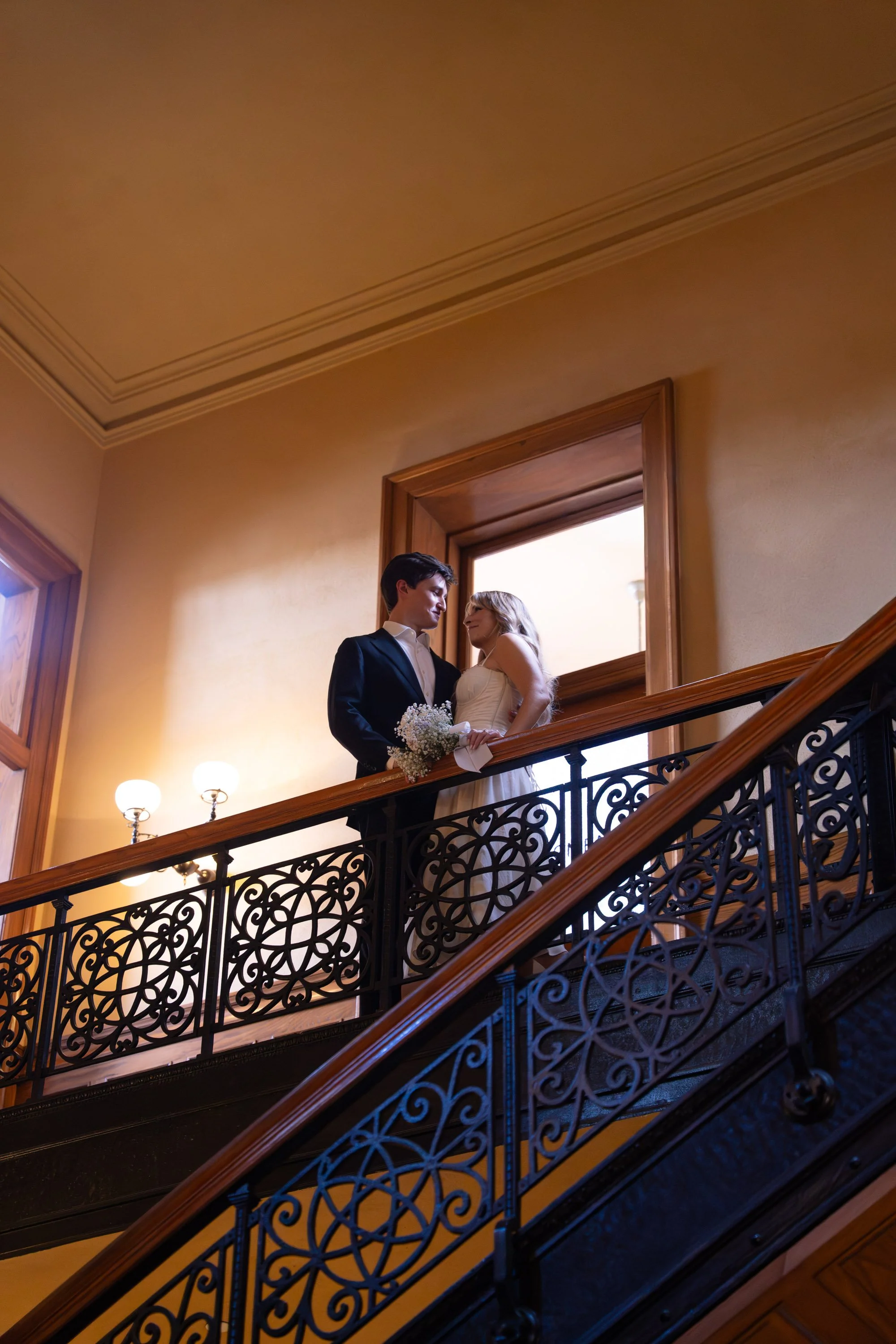 Bride and groom smiling after their courthouse marriage inside the Old Orange County Courthouse in Santa Ana, surrounded by vintage architecture and timeless charm.