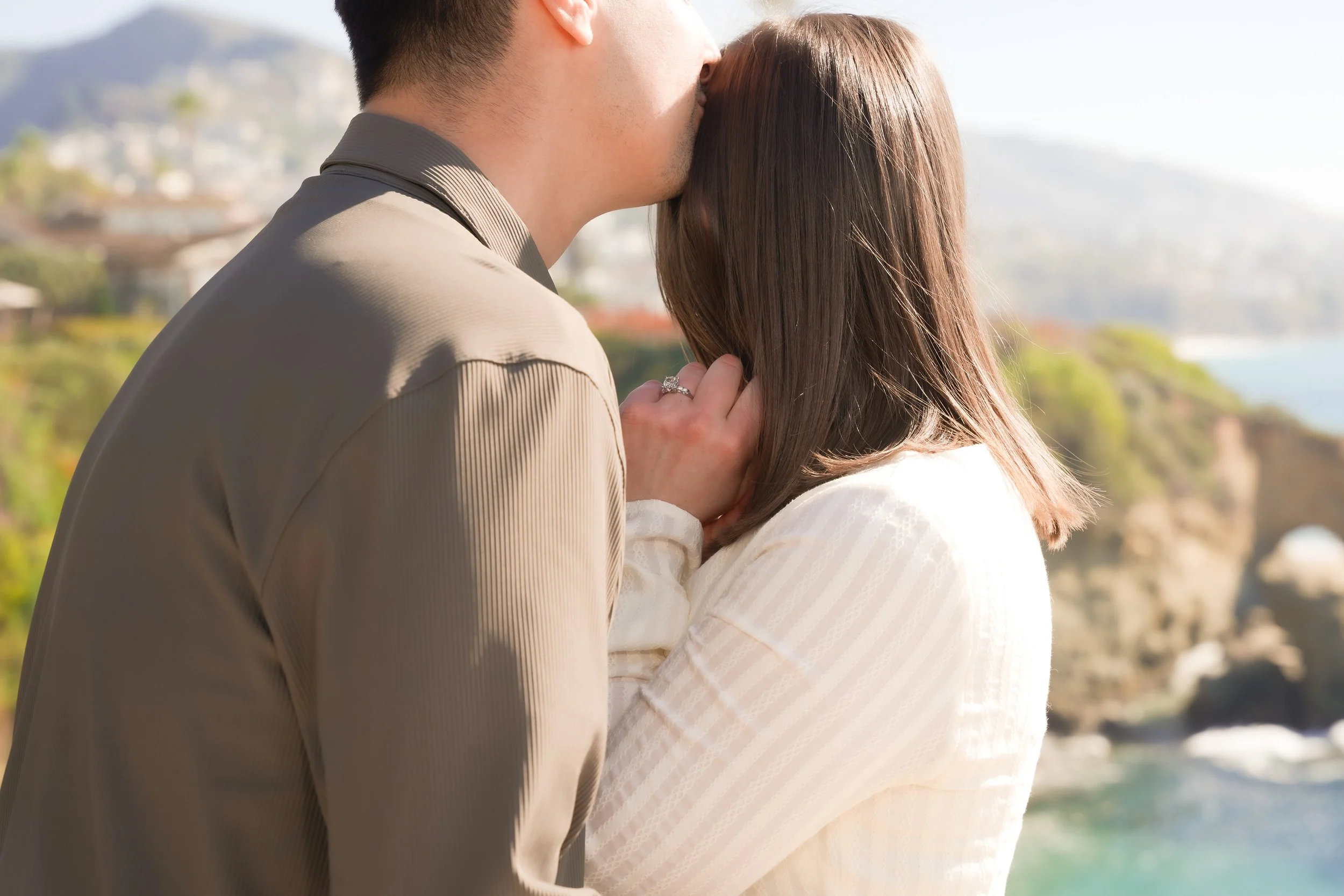 A romantic surprise proposal at Treasure Island Park, Laguna Beach, photographed above the shoreline of Montage Beach.