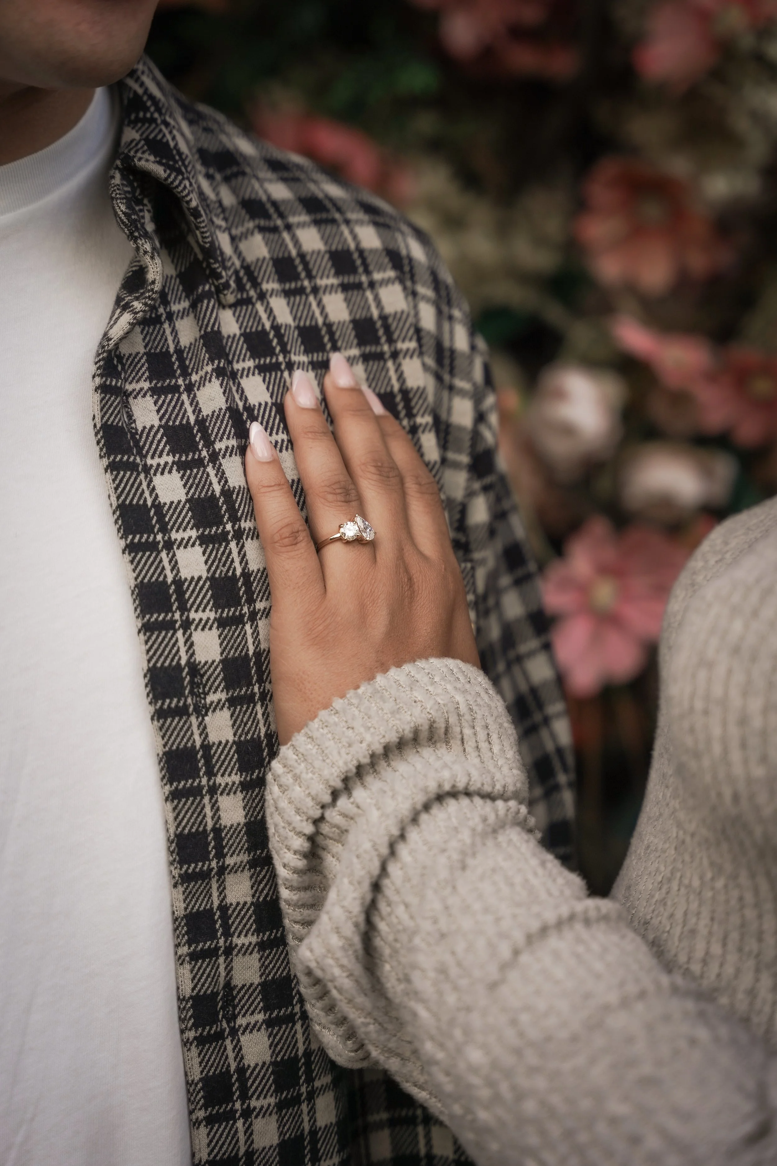 Intimate portrait of the newly engaged couple at Estancia La Jolla, framed by lush gardens and the iconic Wishing Tree.