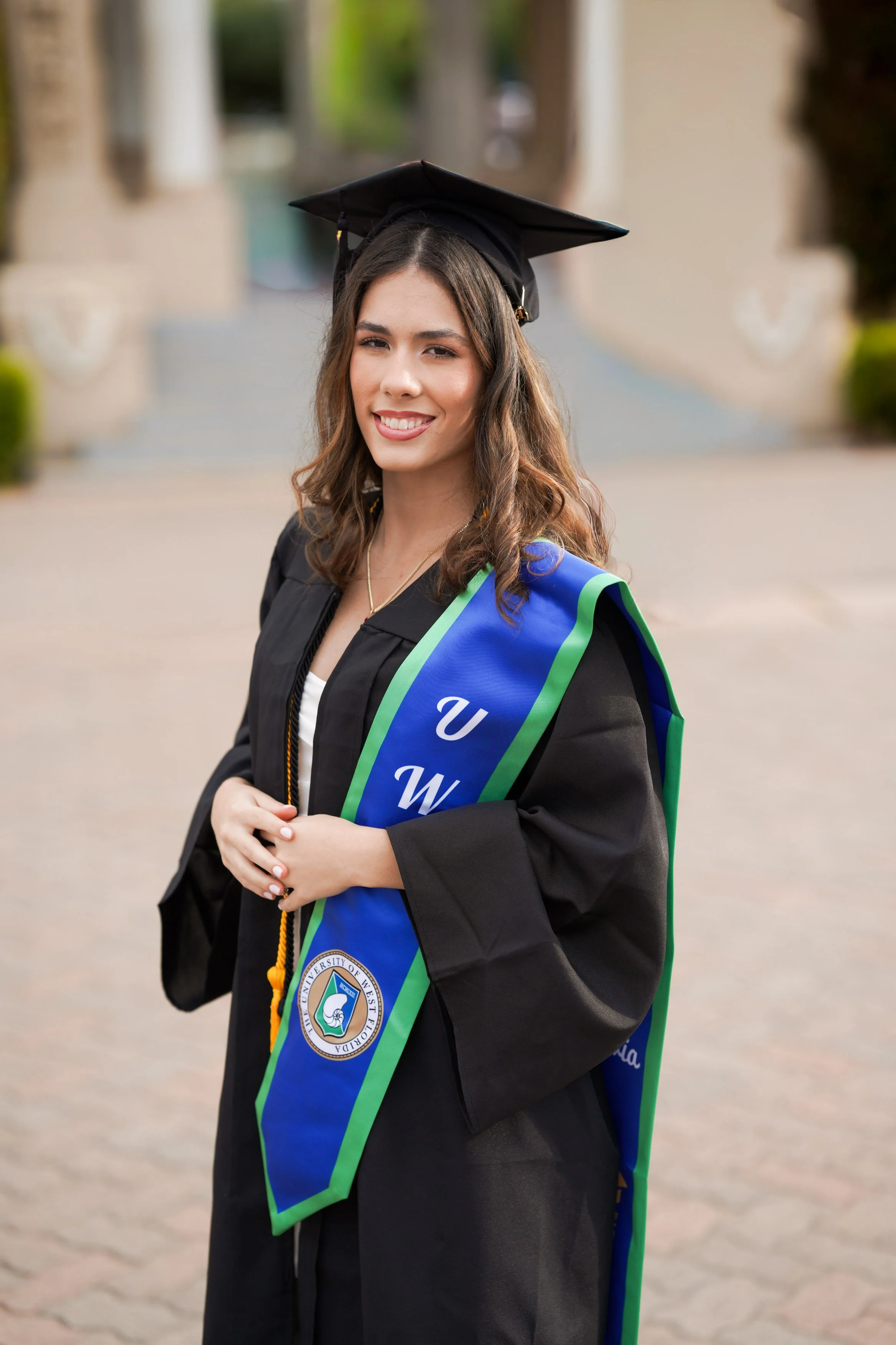 A UWF grad marking their achievement with cap and gown photography in San Diego’s historic Balboa Park.