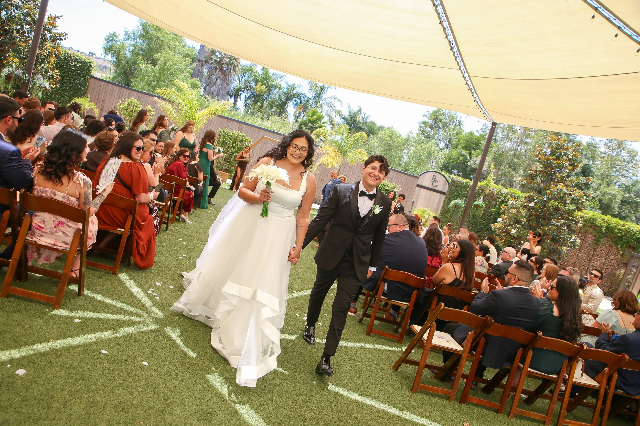 Just married couple celebrating with guests after their River Garden wedding ceremony.