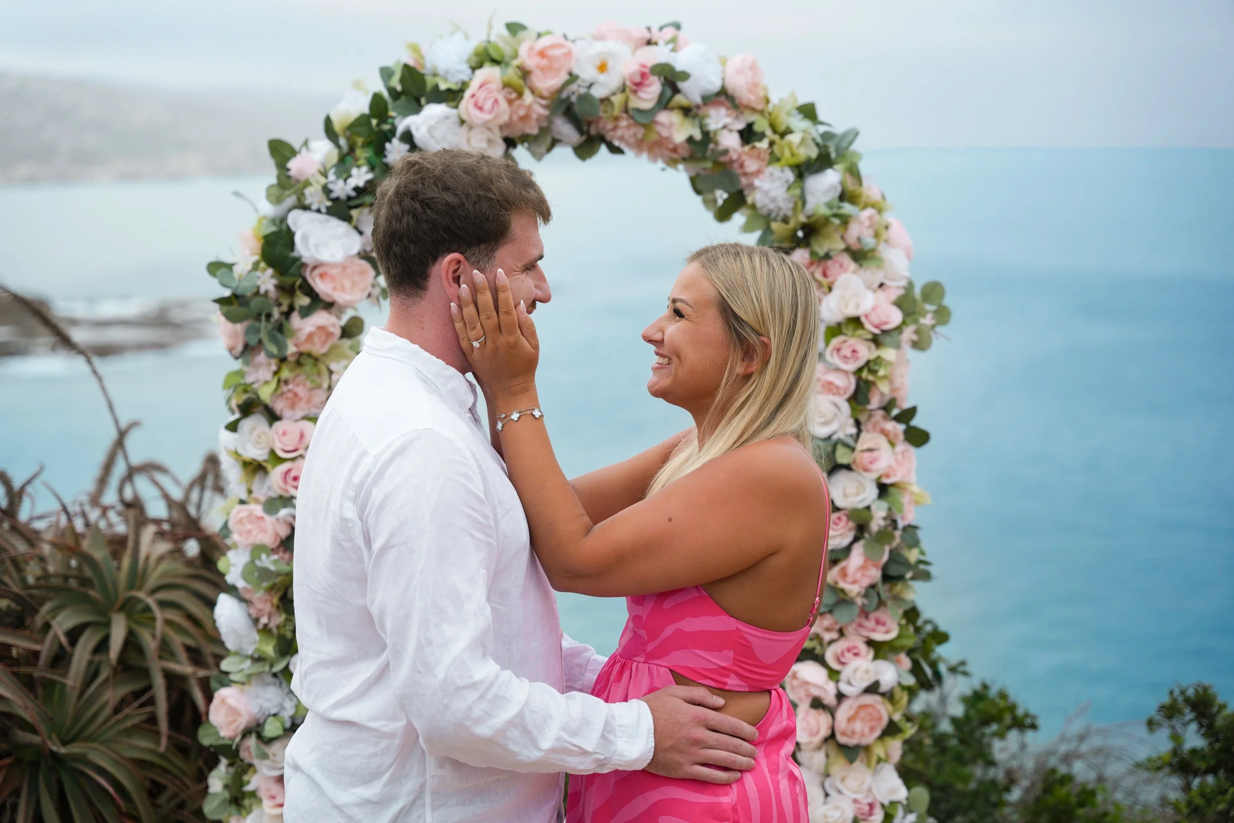 Laguna Beach surprise proposal for a couple visiting from the United Kingdom, featuring romantic floral decorations.