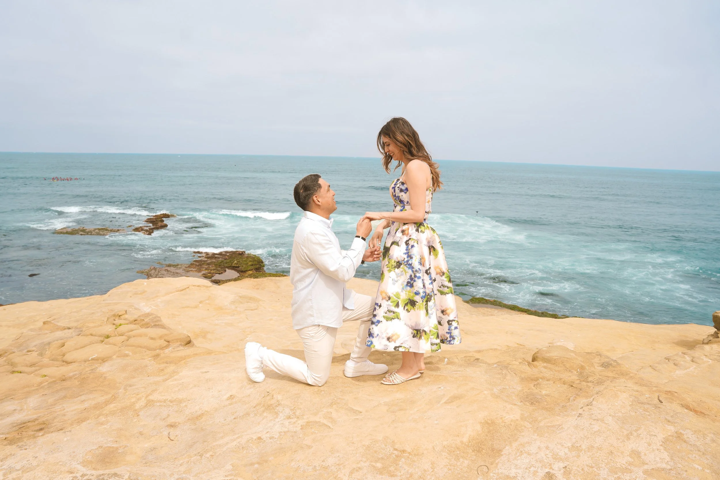 ALT TEXT  Surprise proposal at La Jolla Seal Rock overlooking the Pacific Ocean, captured during a Last Minute Yes proposal package in San Diego.