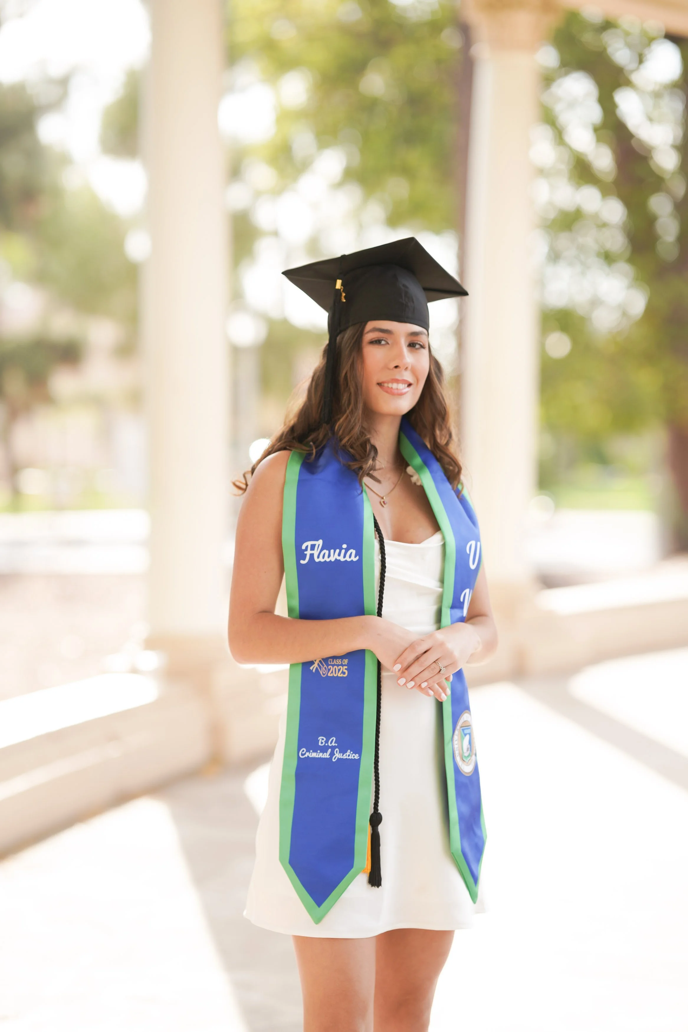 San Diego graduation milestone session at Balboa Park for a proud UWF graduate in cap and gown.
