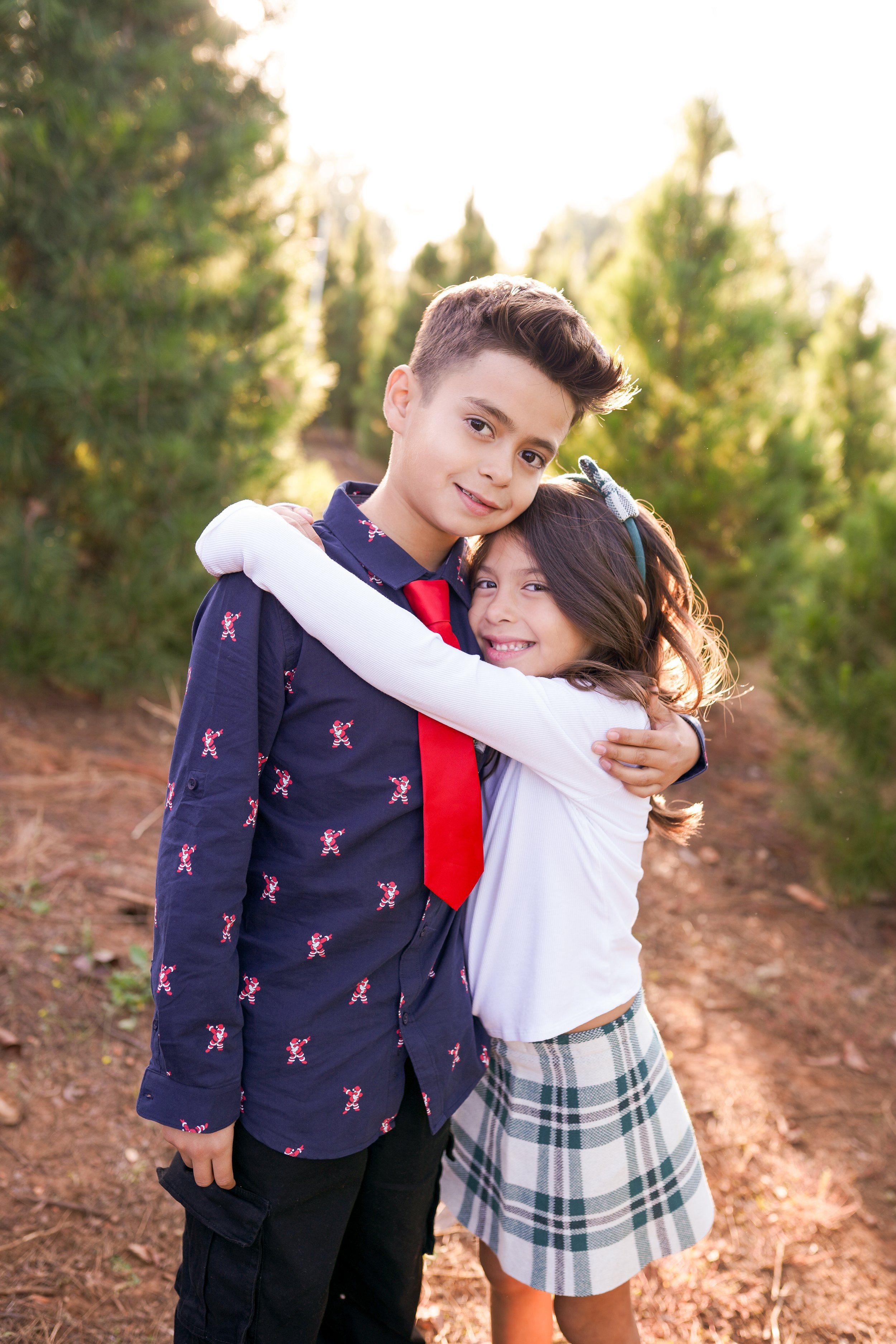 A cozy holiday session capturing a family's joy as they picked out their Christmas tree and placed the star on top. A beautiful moment of togetherness and new traditions—perfect for holiday family photography filled with warmth and cheer.