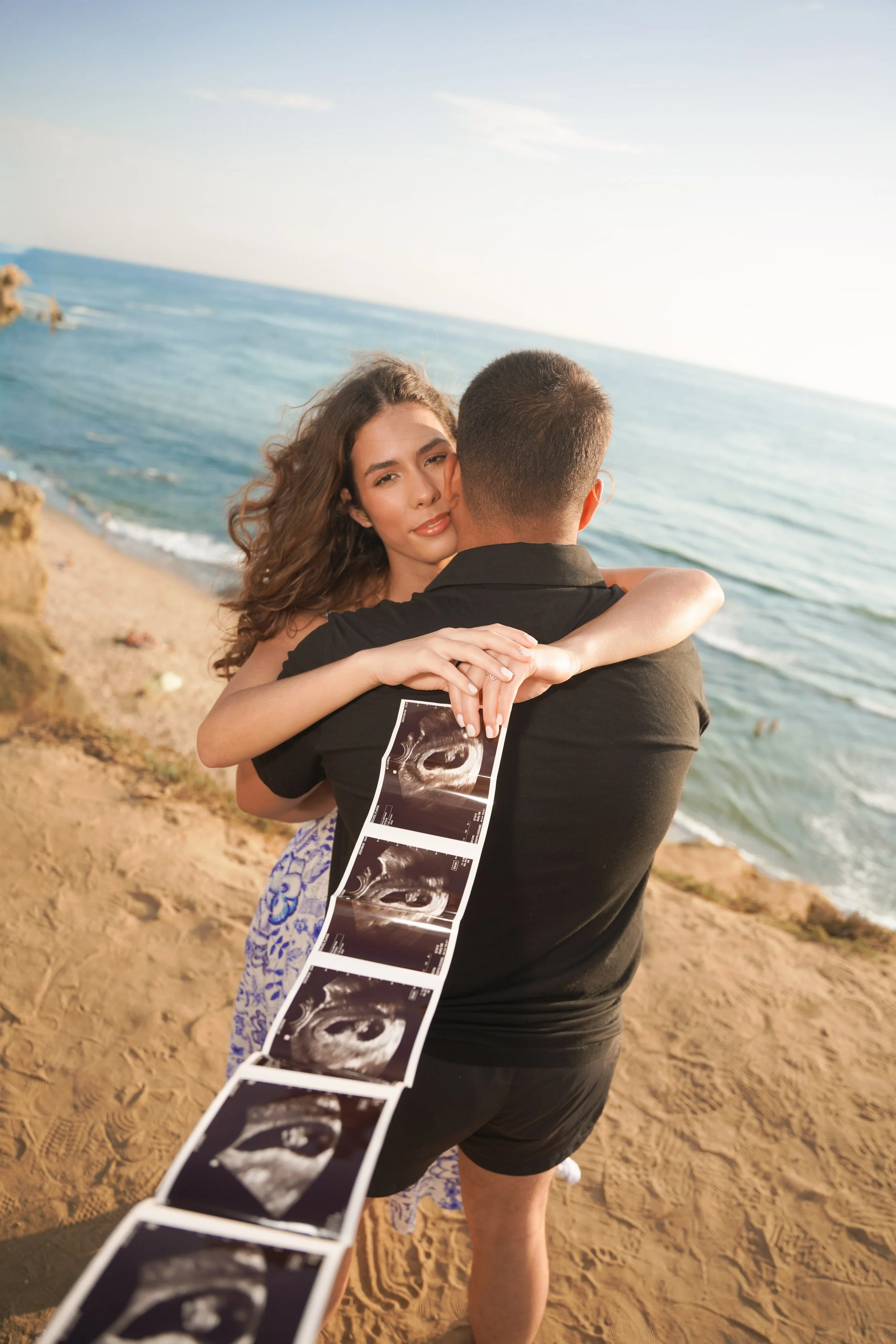 Sunset Cliffs San Diego maternity and baby announcement photography with glowing skies, soft golden light, and romantic ocean views, schedule your professional reveal photography session now.