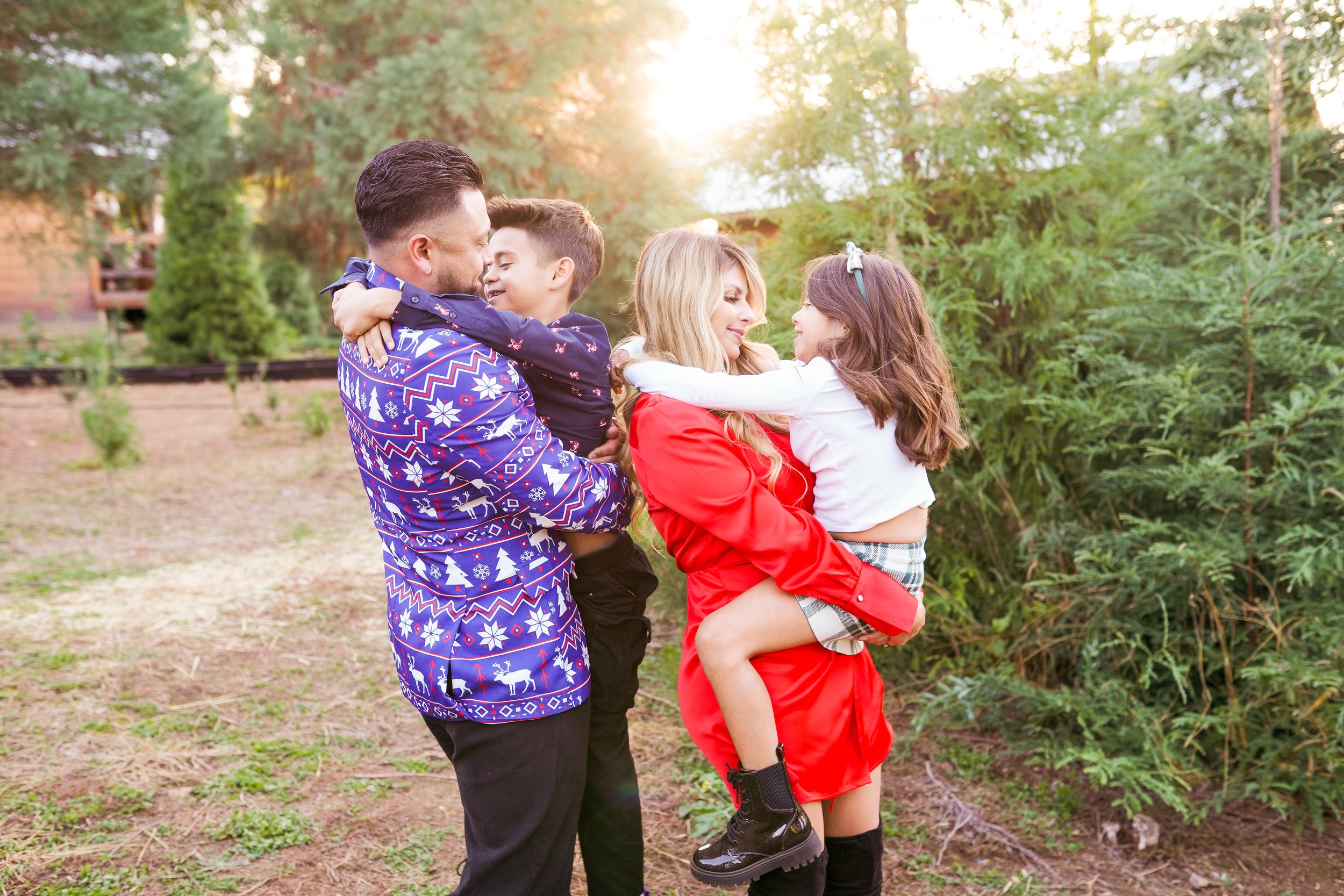 A cozy holiday session capturing a family's joy as they picked out their Christmas tree and placed the star on top. A beautiful moment of togetherness and new traditions—perfect for holiday family photography filled with warmth and cheer.