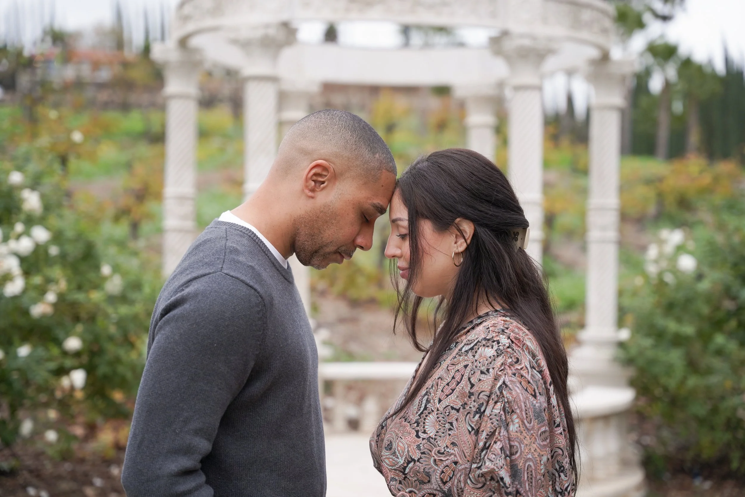 Surprise proposal photography at Europa Village Winery in Temecula featuring Michael and Kristina touching foreheads in front of the C’est La Vie gazebo