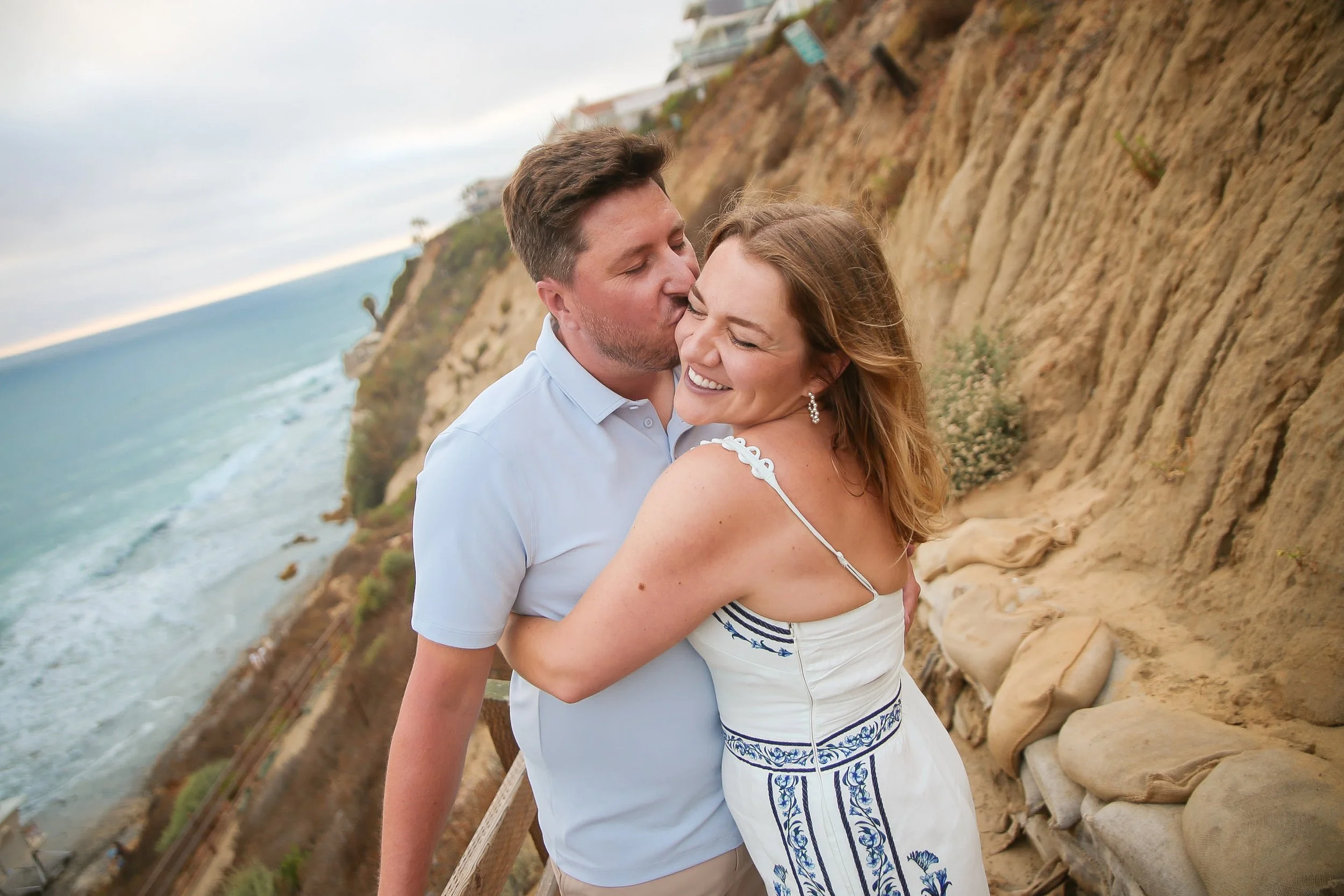 Romantic sunset engagement session at Leucadia State Beach in Encinitas, featuring Brett and Mary Bray along the Pacific shoreline.