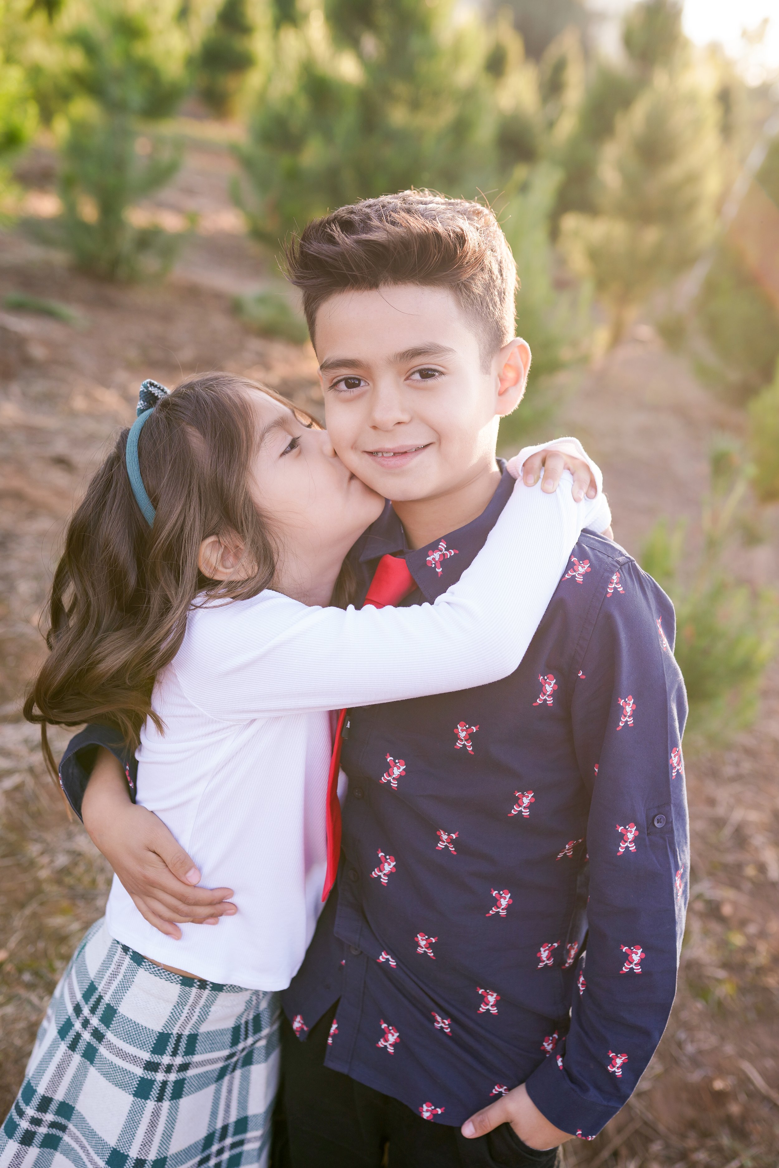 A cozy holiday session capturing a family's joy as they picked out their Christmas tree and placed the star on top. A beautiful moment of togetherness and new traditions—perfect for holiday family photography filled with warmth and cheer.