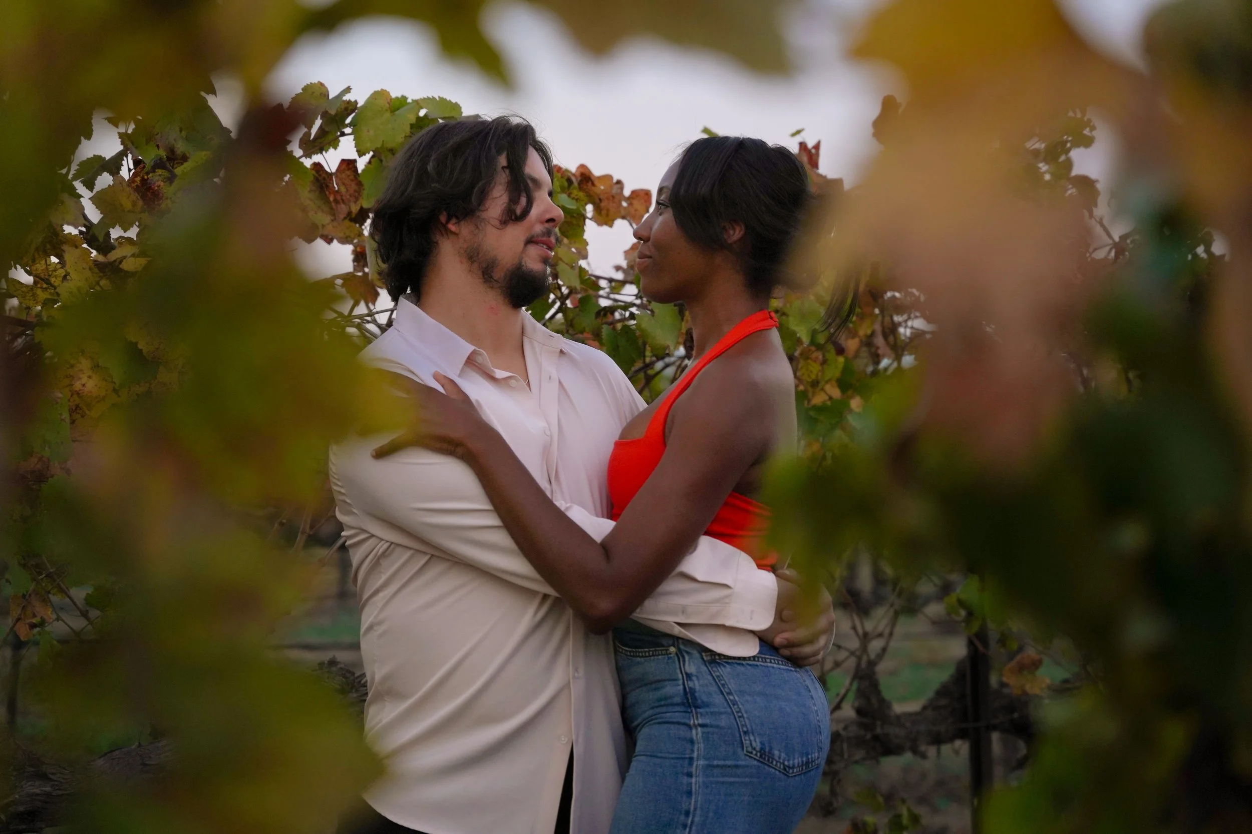 Post-engagement portrait captured in Temecula vineyards following a surprise proposal, showcasing natural connection and golden-hour light