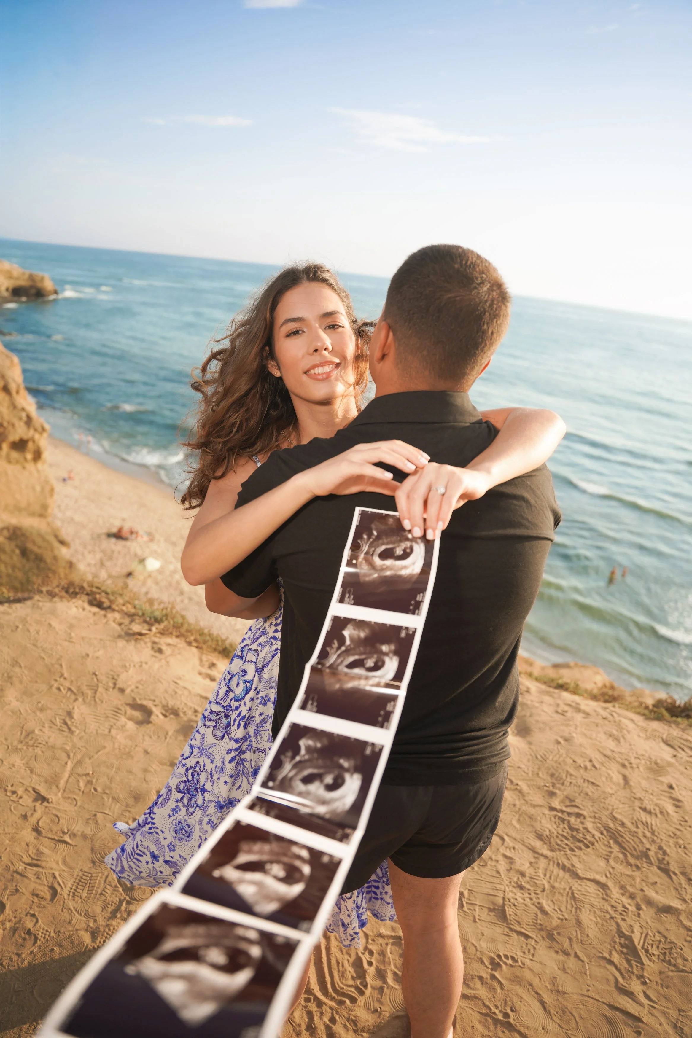 San Diego baby reveal photography during golden hour at Sunset Cliffs with cinematic skies, ocean cliffs, and breathtaking natural beauty, book your unforgettable announcement shoot with us today.