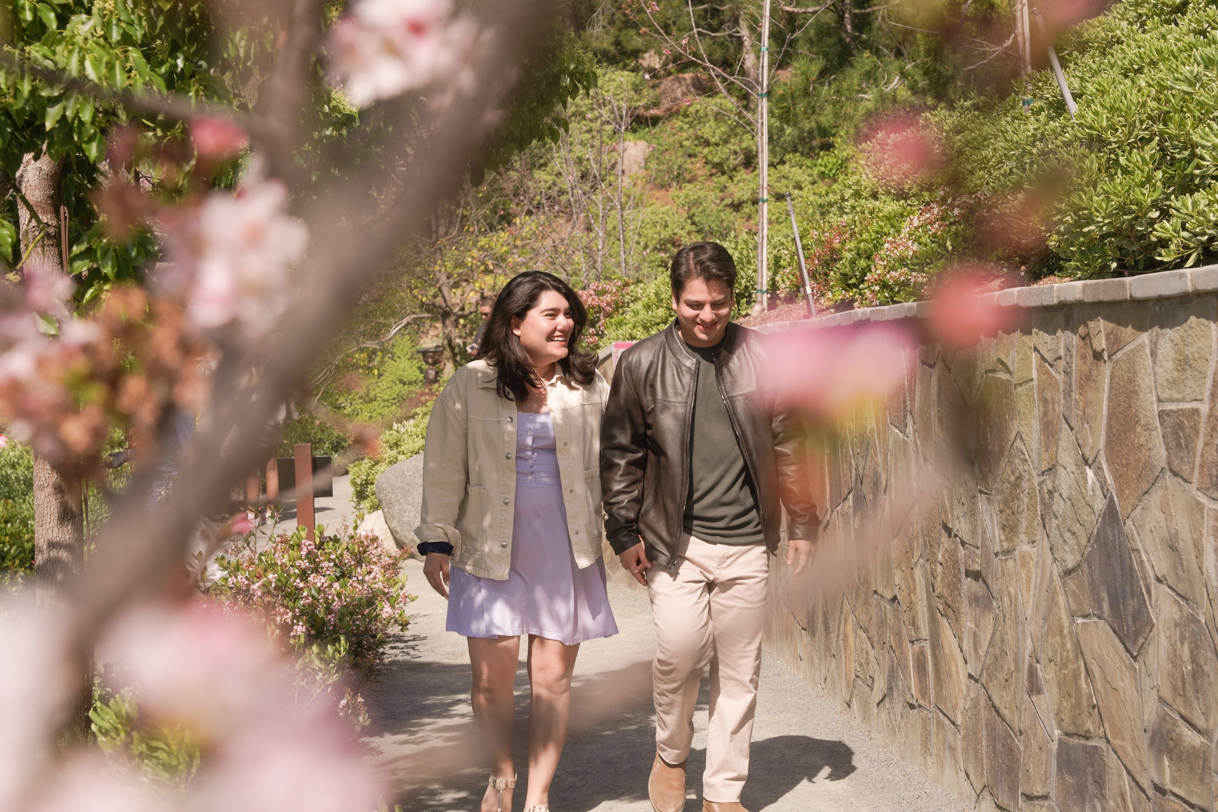 Couple kissing at Japanese Friendship Garden post-proposal engagement photo