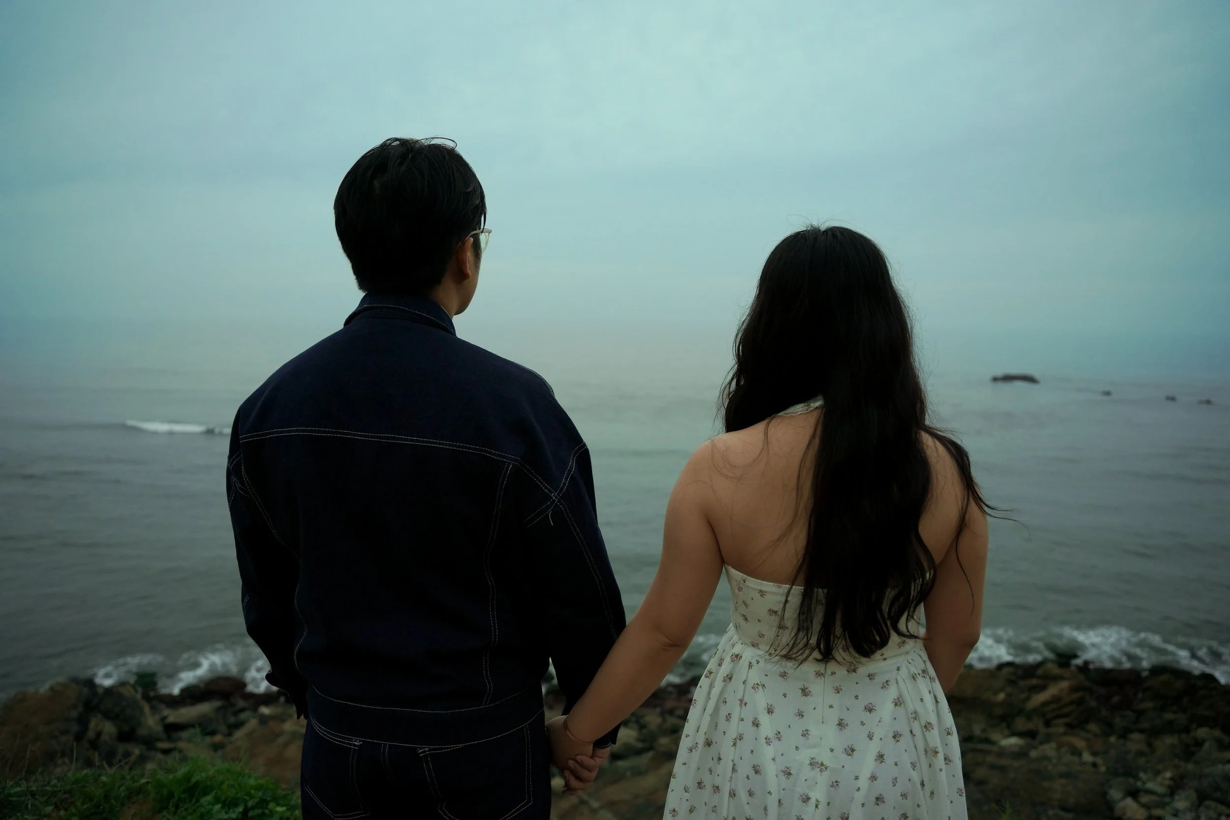 Surprise proposal overlooking the Palos Verdes Estates Bluff Trail during blue hour, with dramatic ocean cliffs, soft coastal light, and an intimate engagement moment against the Pacific coastline.