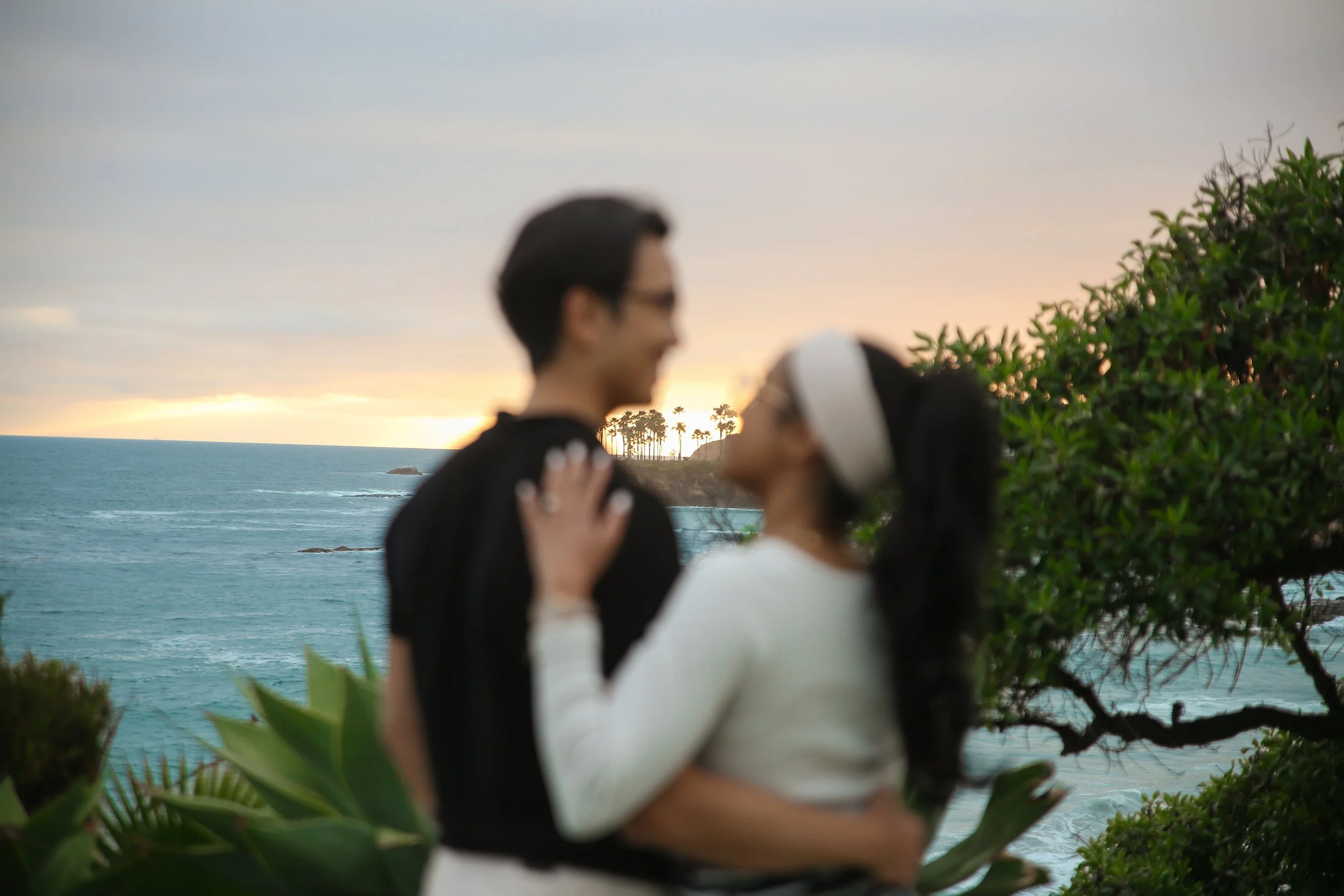 Golden hour engagement portraits at Heisler Park showcasing natural emotions and Southern California coastal beauty.
