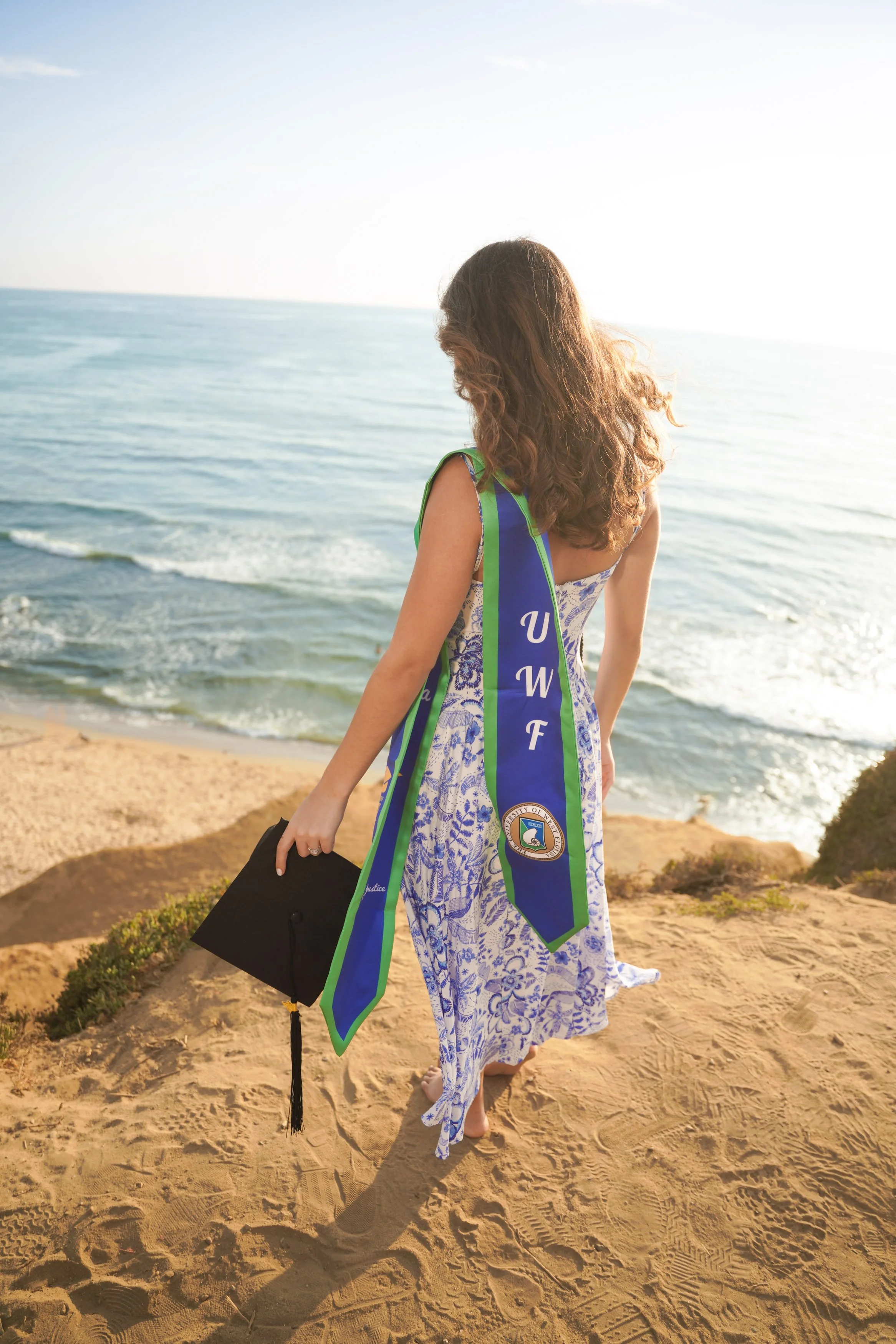 Professional San Diego graduation milestone session at Sunset Cliffs, combining golden hour light, cap and gown portraits, and the beauty of California’s coast.