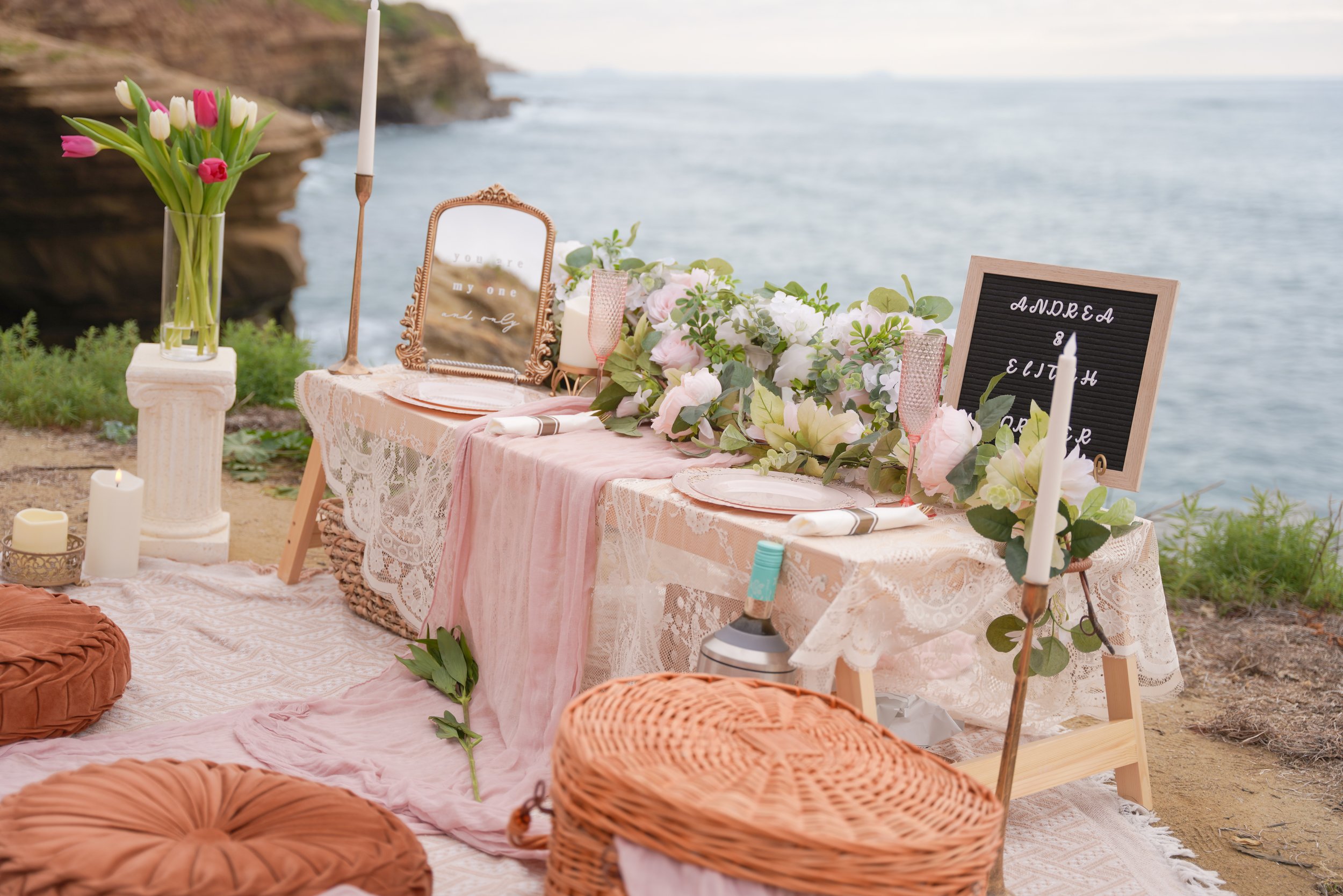 Luxury boho proposal picnic at Sunset Cliffs San Diego photographed during sunset with ocean cliffs and styled details