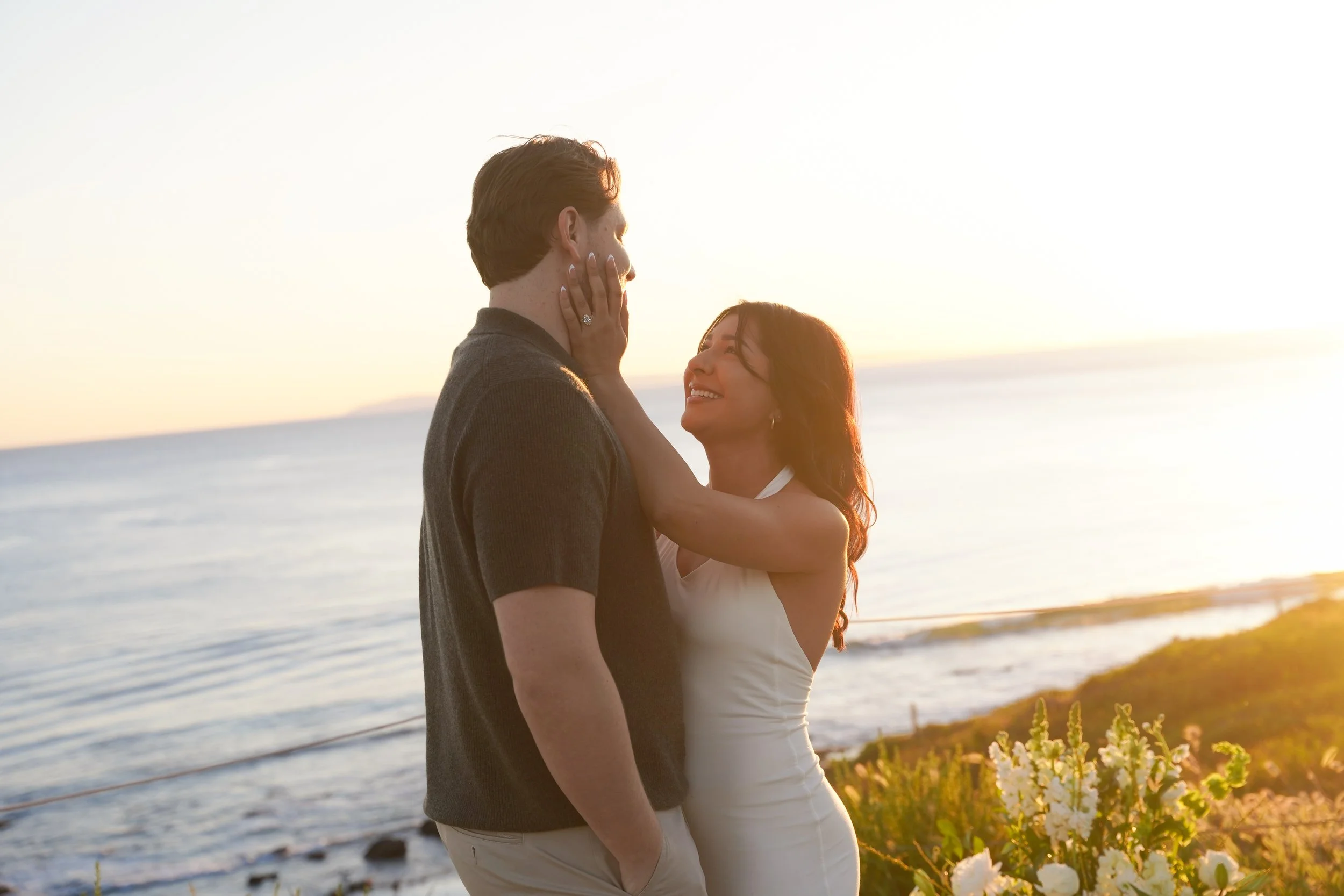 engaged couple sharing a quiet moment after a surprise proposal in Newport Beach, captured by a Newport Beach surprise proposal photographer with natural light and a clean coastal backdrop