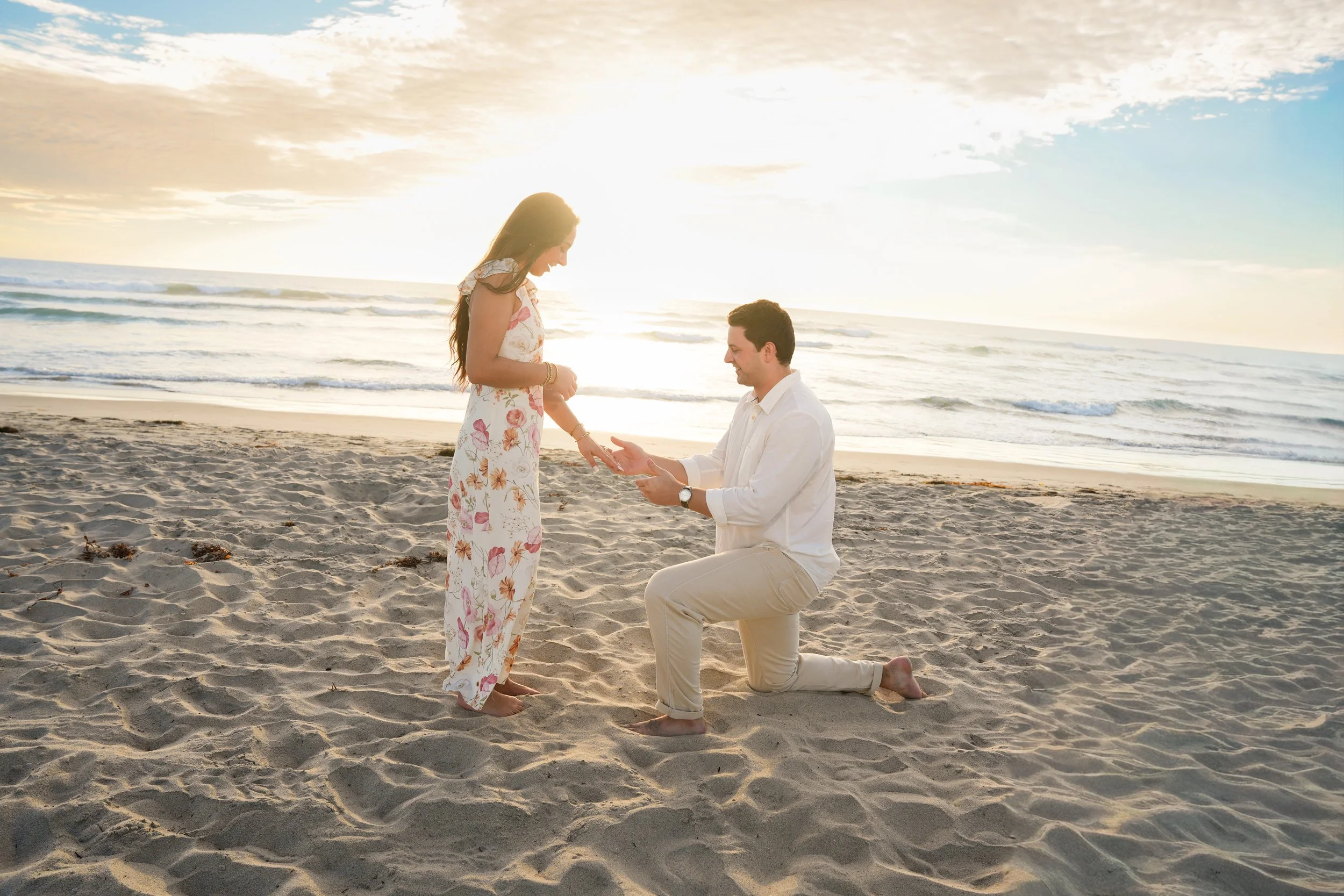 Sunset surprise proposal on Del Mar Beach in San Diego, California.