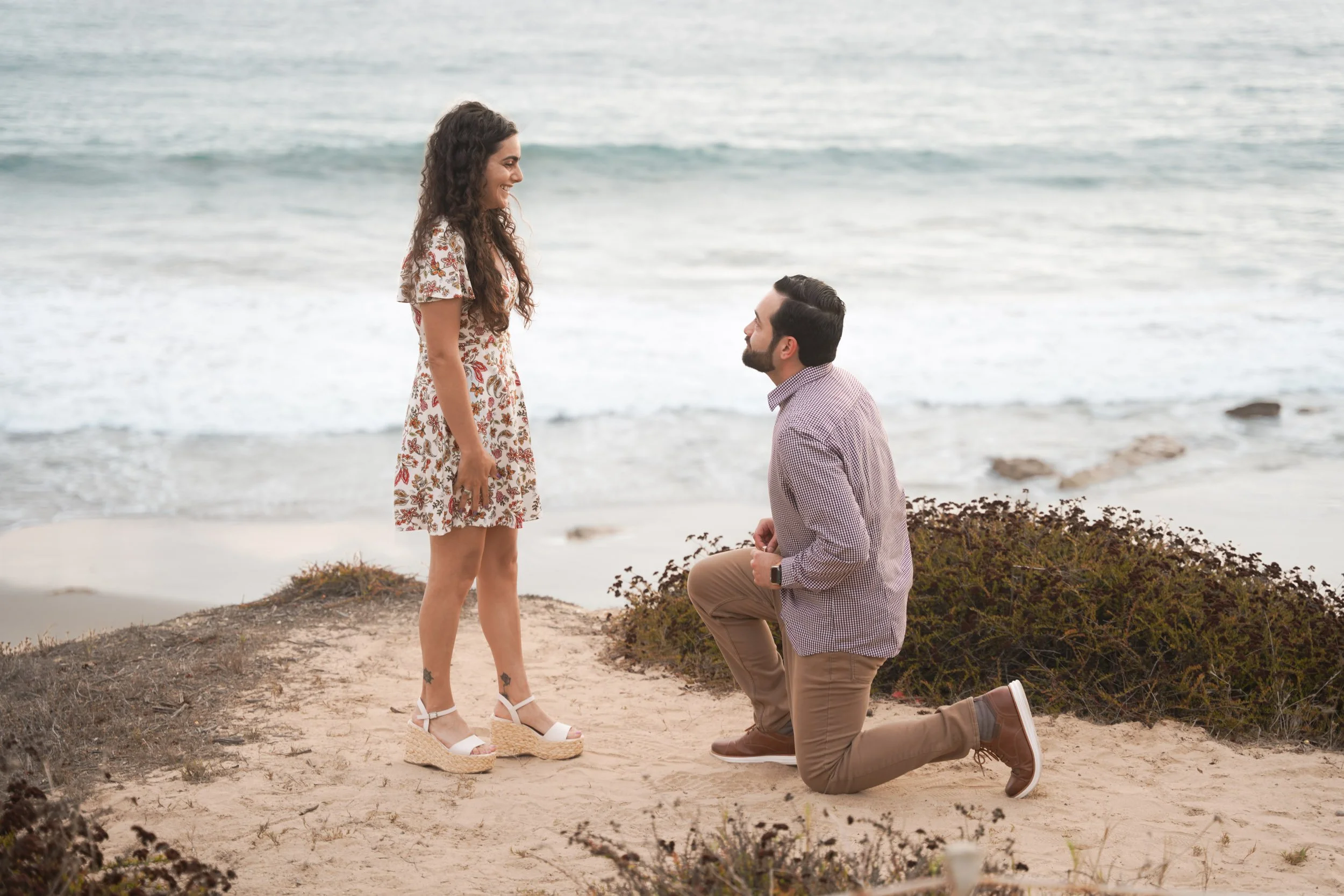 Romantic engagement at Crystal Cove beach cliffs, captured by expert Orange County proposal photographers.