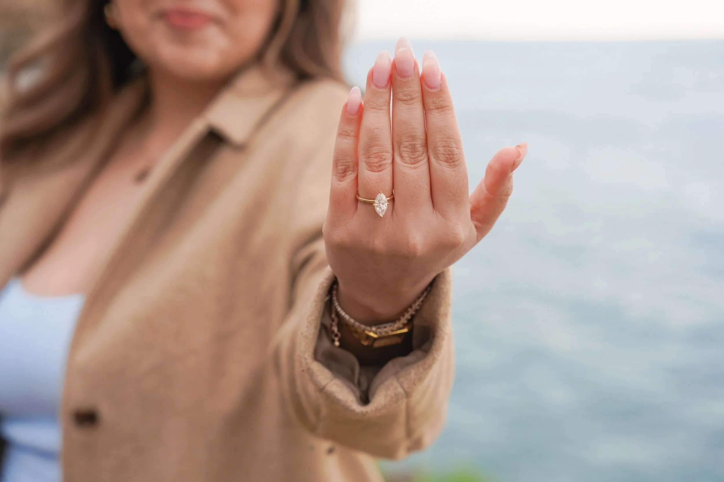 San Diego Sunset Cliffs engagement proposal with curated boho picnic design overlooking dramatic coastal cliffs