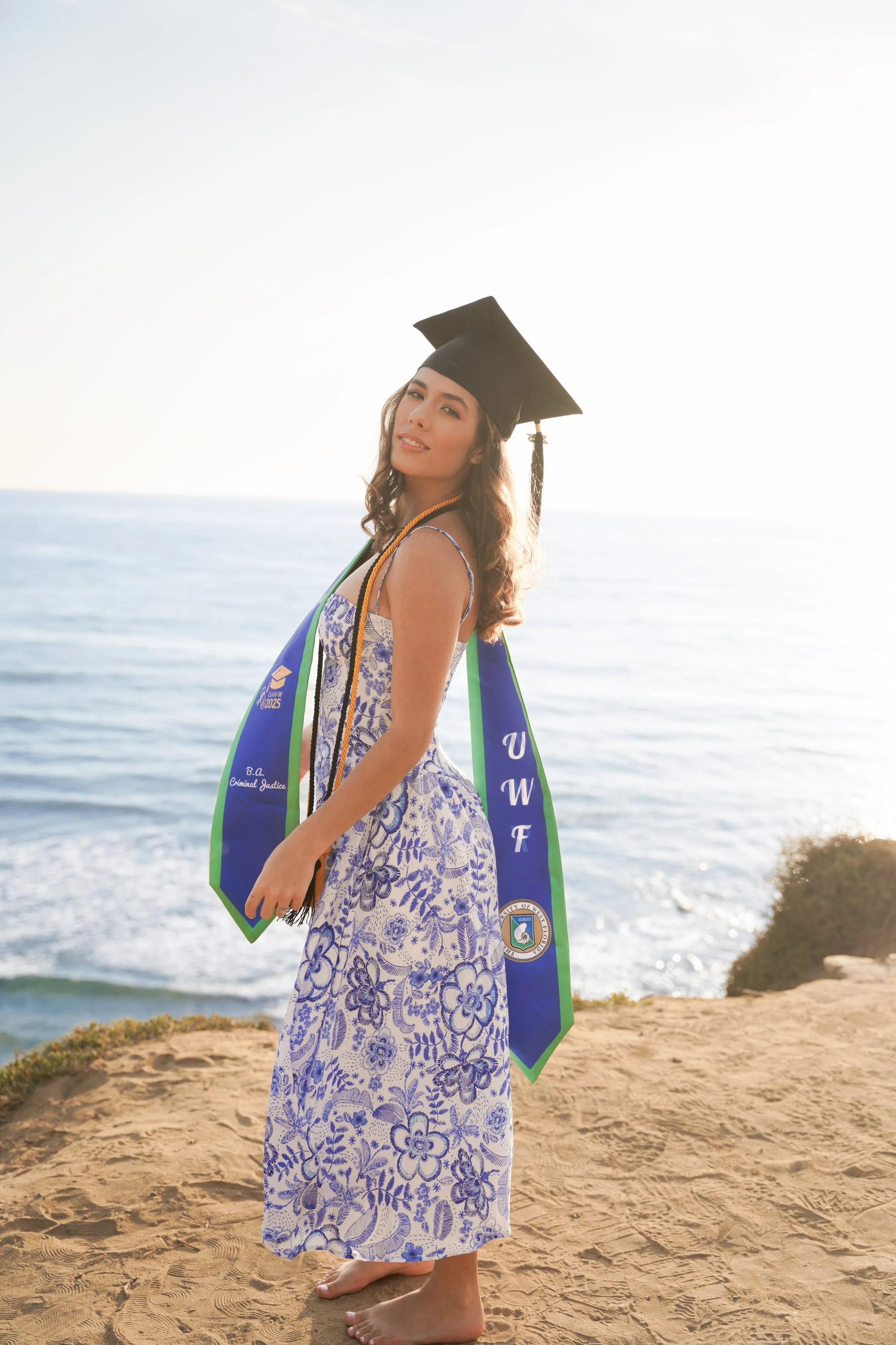 A milestone graduation photoshoot at Sunset Cliffs, San Diego, where golden hour natural light and dramatic coastal cliffs create breathtaking cap and gown portraits.