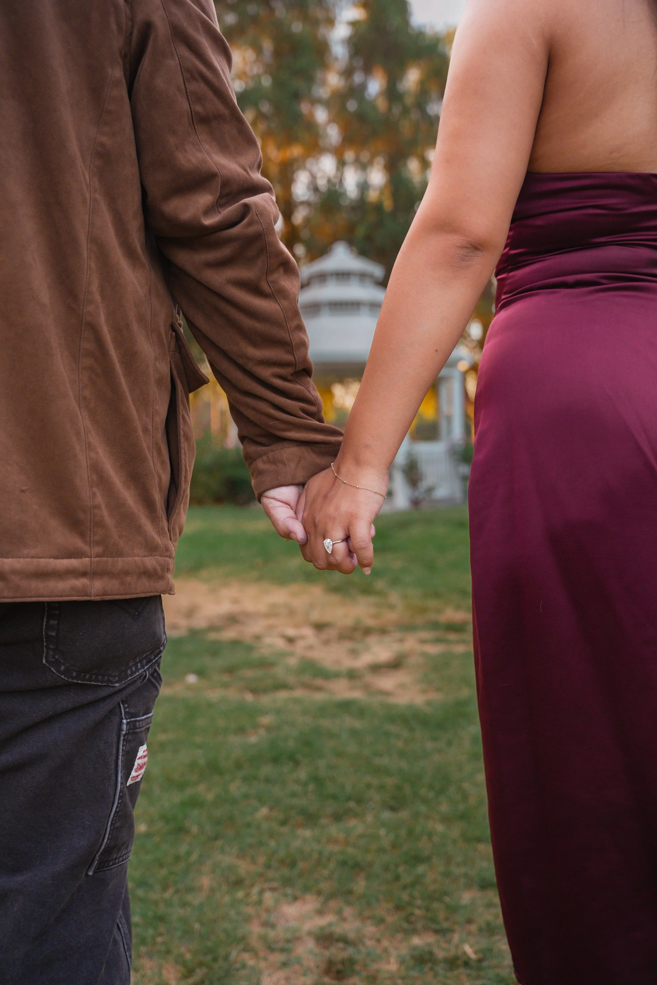 Couple embracing after a proposal at Fairmount Park.