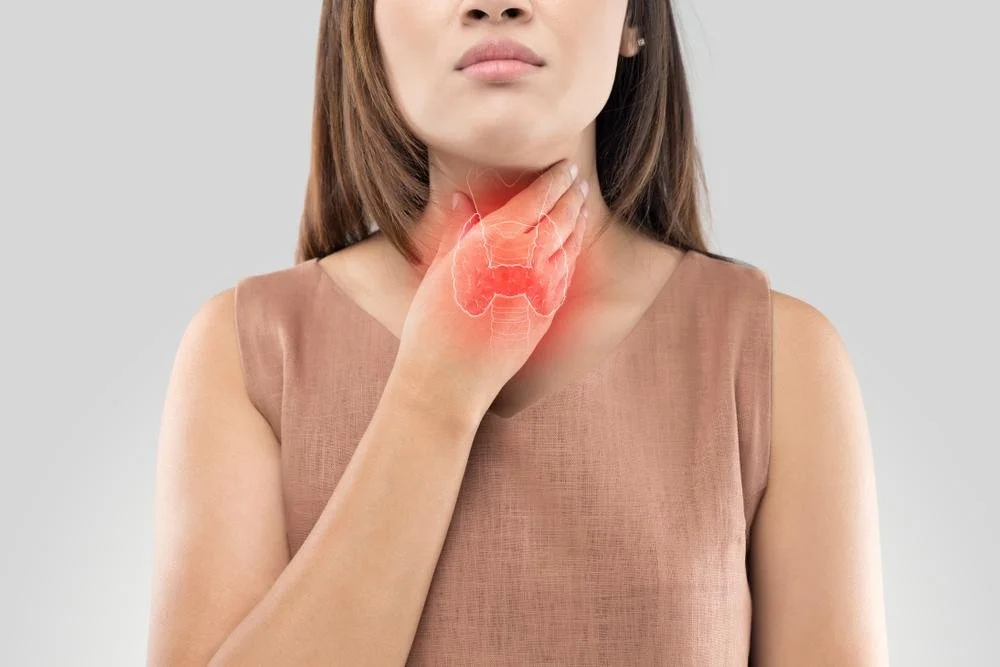 Woman feeling her thyroid gland, thyroid deficiency