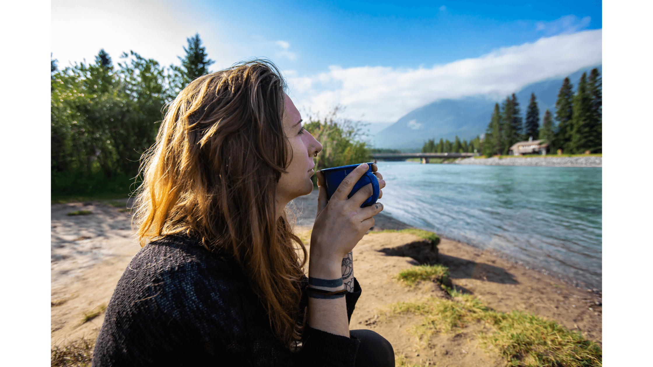 Woman drinking coffee mold-free by river. Jpg.