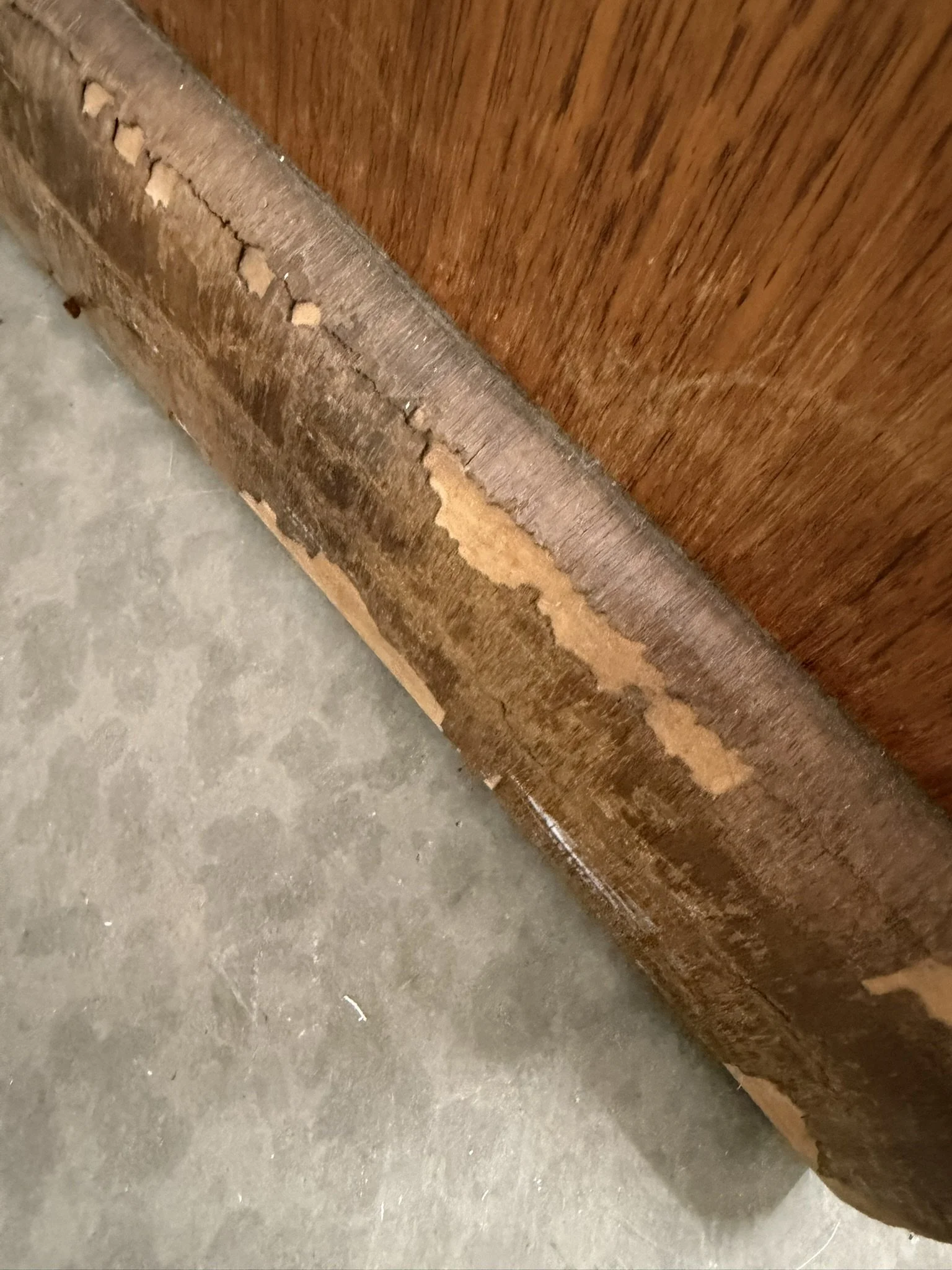 Damage Close-Up: Front Base - 

The veneer along the bottom edge is peeling badly, revealing the substrate underneath.  Veneering was a common and economical way to showcase stunning grain patterns.  Lane used this method often to achieve that iconic