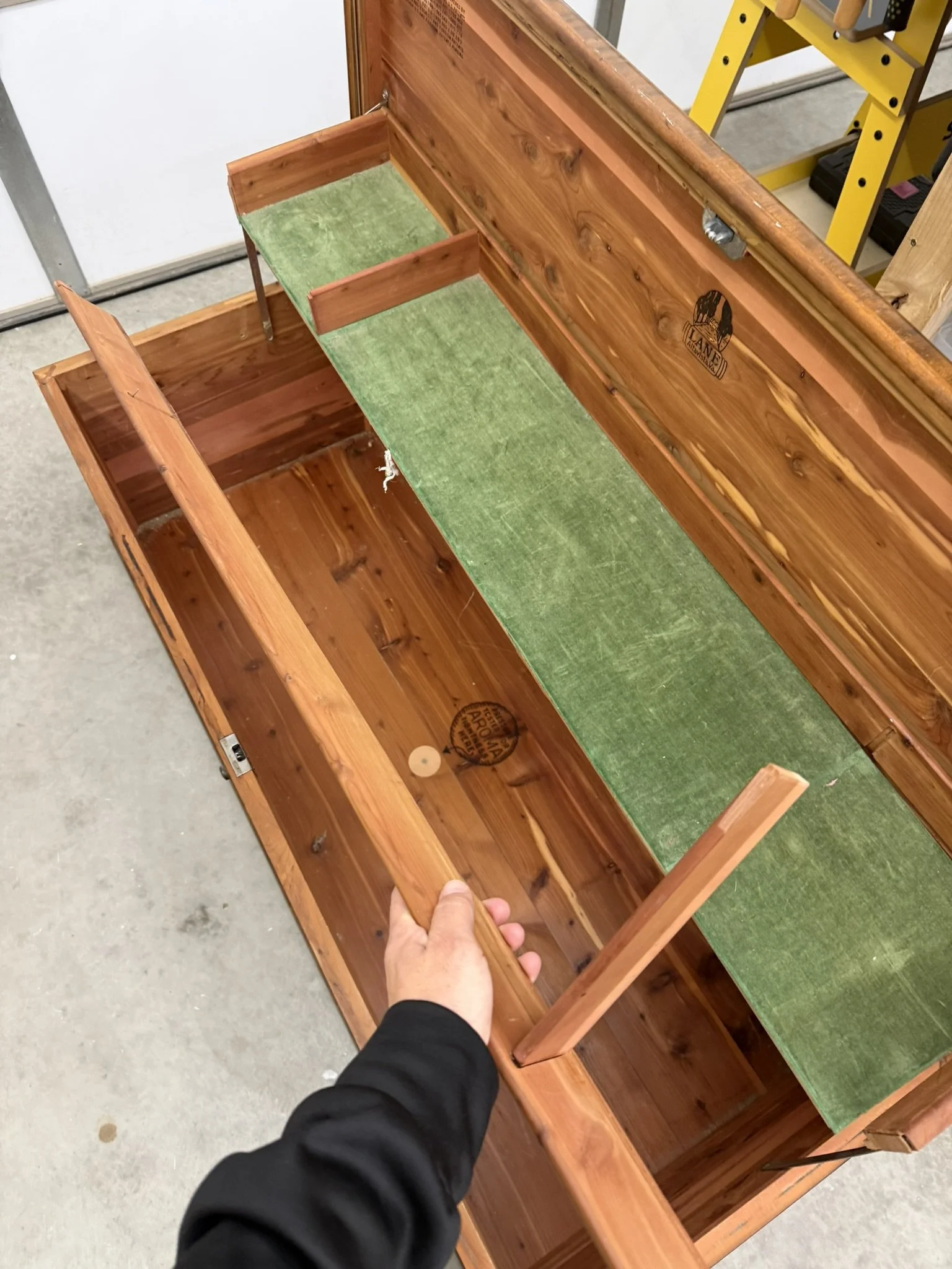 The tray was designed to organize smaller items, keeping them separate from the bulk storage below.  That unmistakable cedar aroma is faint but still present a testament to Lane’s craftsmanship and the natural preservative qualities of cedar wood.  A