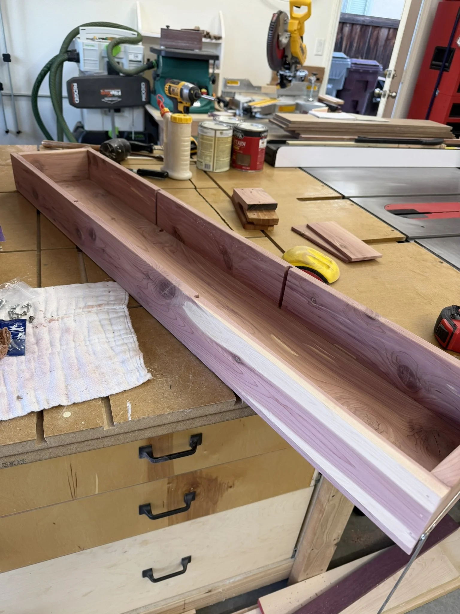 Rebuilding the Interior Shelf - 

Freshly planed cedar boards were cut, assembled, and test-fit to rebuild the interior shelf of the chest.  The vibrant purple and cream tones highlight the aromatic cedar's natural beauty.  Each divider was carefully