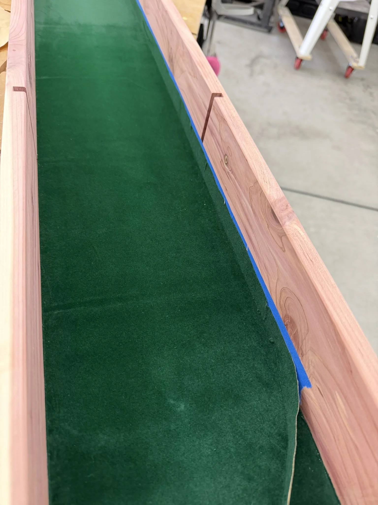Velvet Install - 

Lining the newly built interior shelf with green velvet selected by the client.  Tape protected cedar wall when velvet was razor cut along joint.