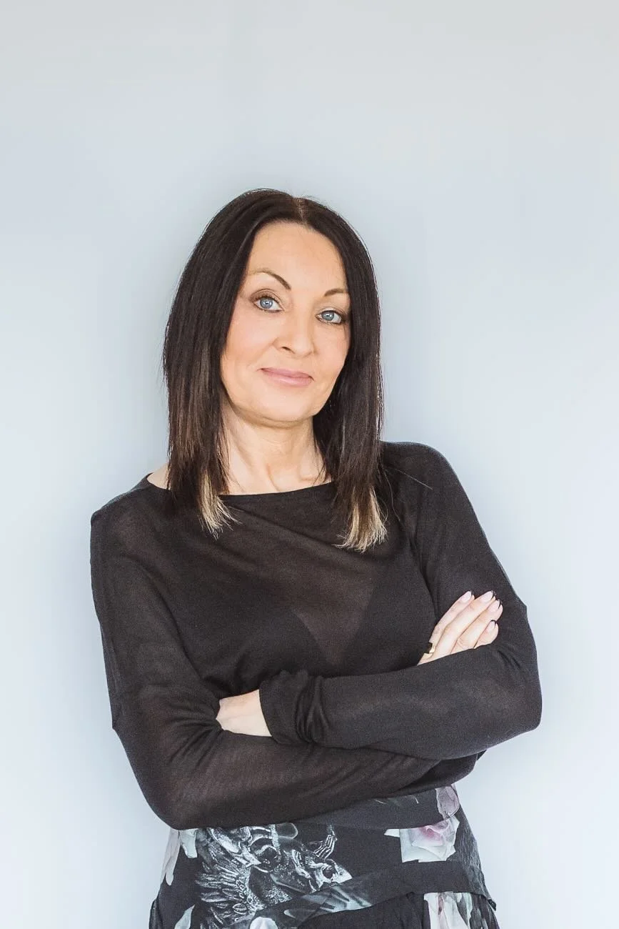 Headshot of the website creator folded arms black jumper smiling