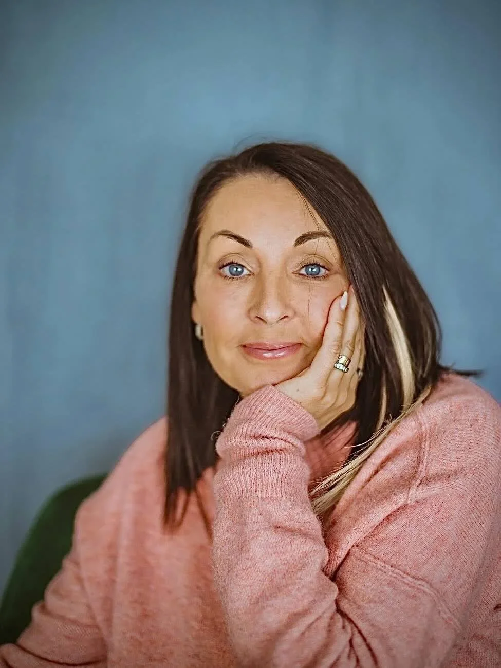Web creator and author headshot with head resting on hand and smiling