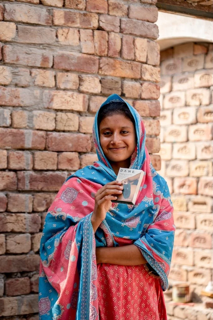 Woman in an ACE Cotton community holding a DAME period product