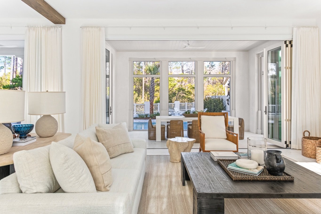 Summer days just feel better in spaces like this. An elevated living space, natural light pouring in, and glass doors that open directly to the pool create the perfect blend of indoor and outdoor living. 

#livingroomideas #indooroutdoorliving #30aho