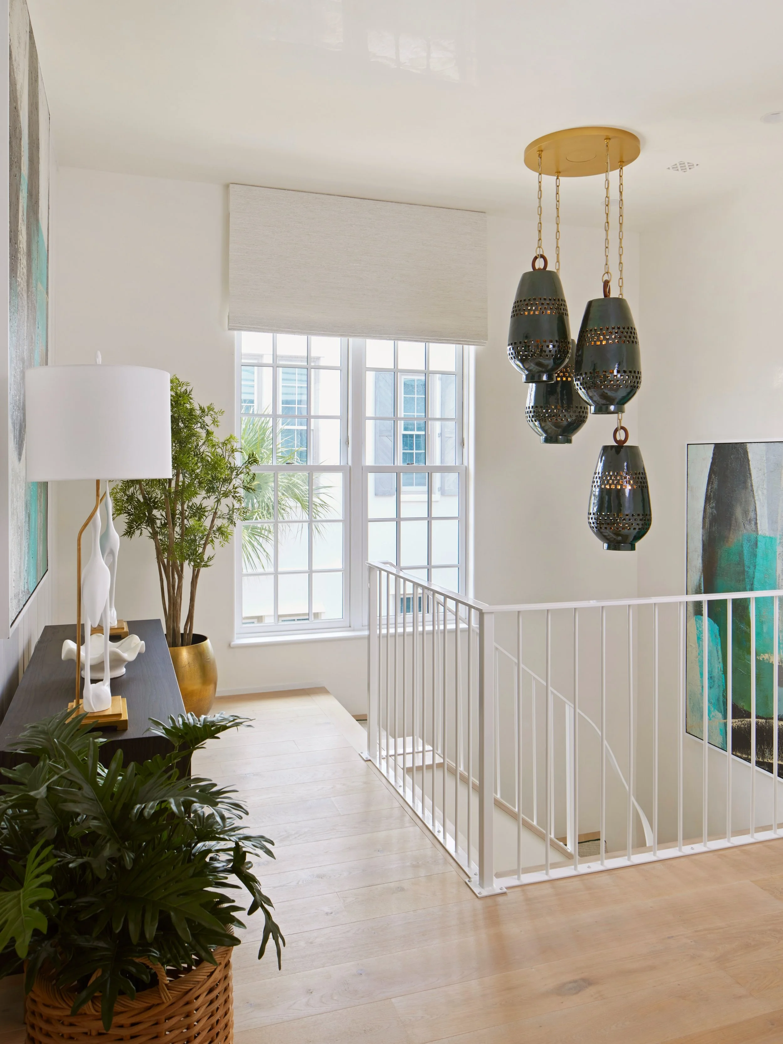 We love the balance of traditional and contemporary elements in this space. Divided-light windows and a simple stair railing provide a classic foundation, while a sculptural light fixture introduces something unexpected. It&rsquo;s the interplay betw