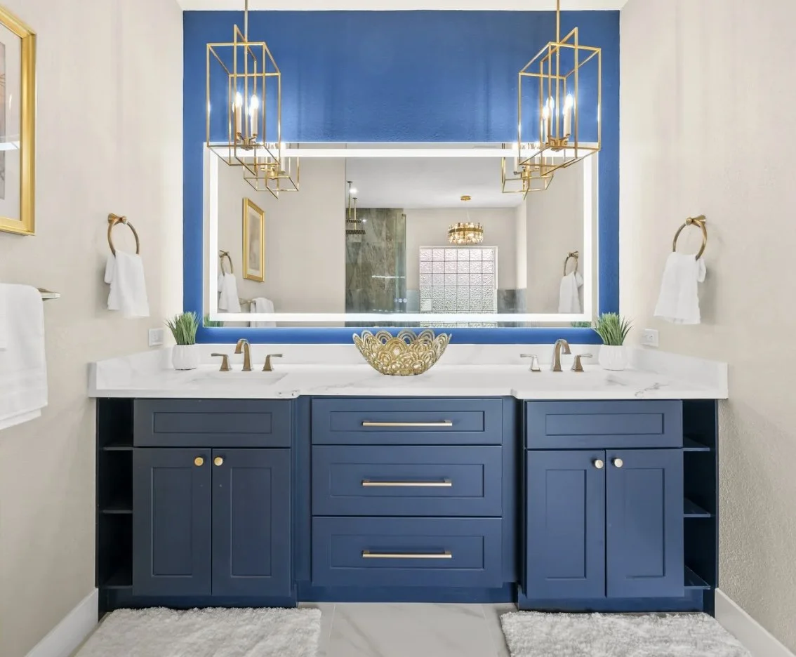 A bold, blue bathroom with gold accents by Khrome Interiors