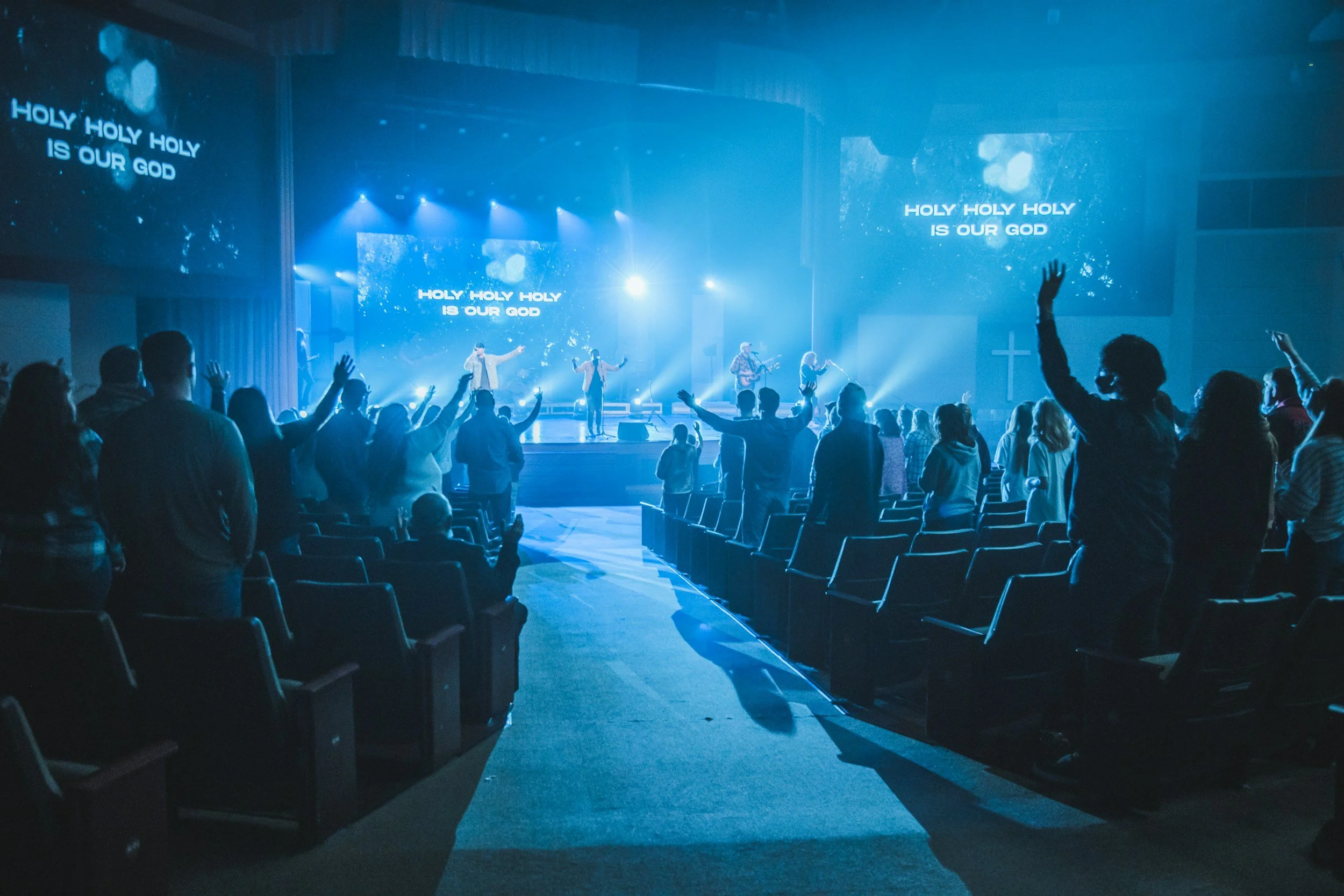 Blue spotlights during a praise church service prepare members for a Sunday sermon