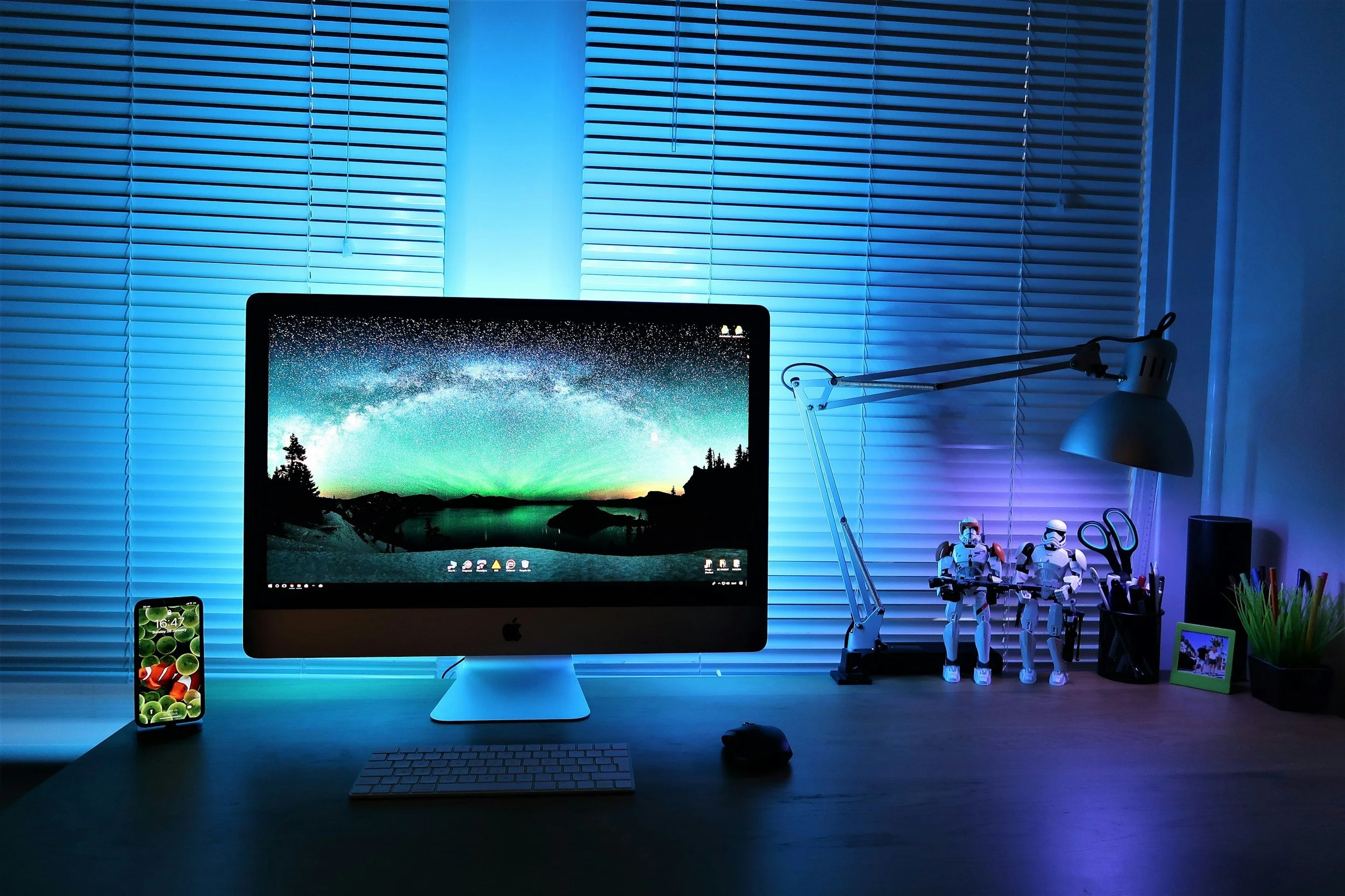 a room lit in blue with a desktop screen and two star wars stormtroopers next to it.