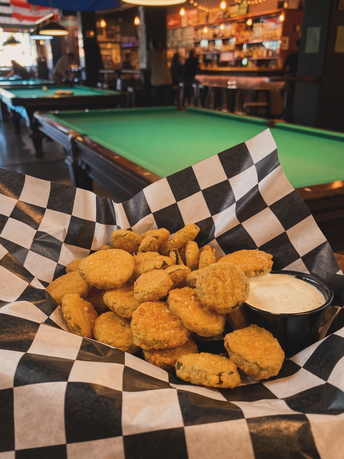 🥒🎱 Pickles and pool. Name a better Pubhouse combo.

Our Fried Pickle Chips are battered, fried, crispy, and served with ranch for maximum dunkability.

Grab a basket, rack up a game, and try not to eat them all before your turn (or do, no judgement