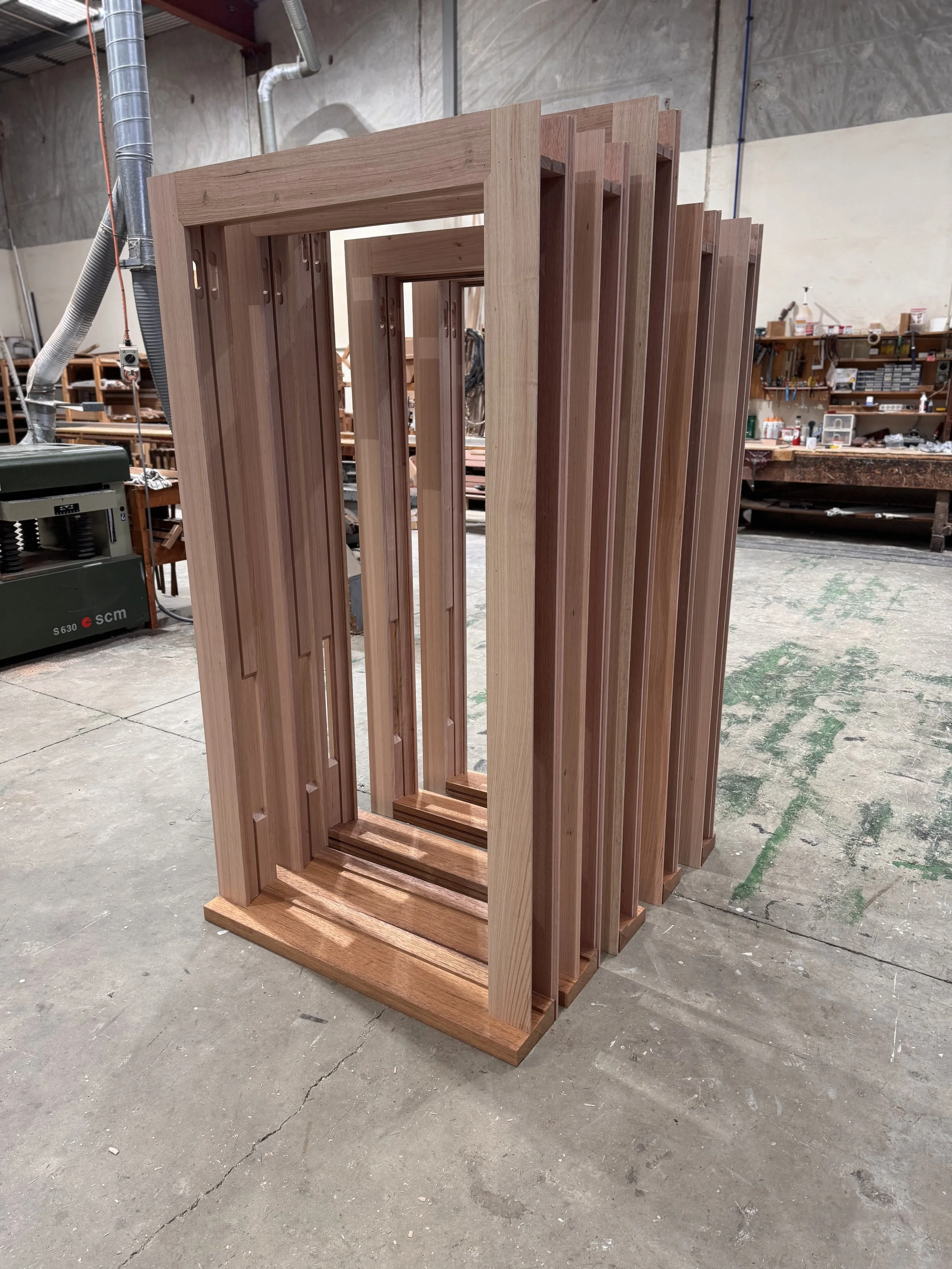 Stacked wooden frames in a workshop.