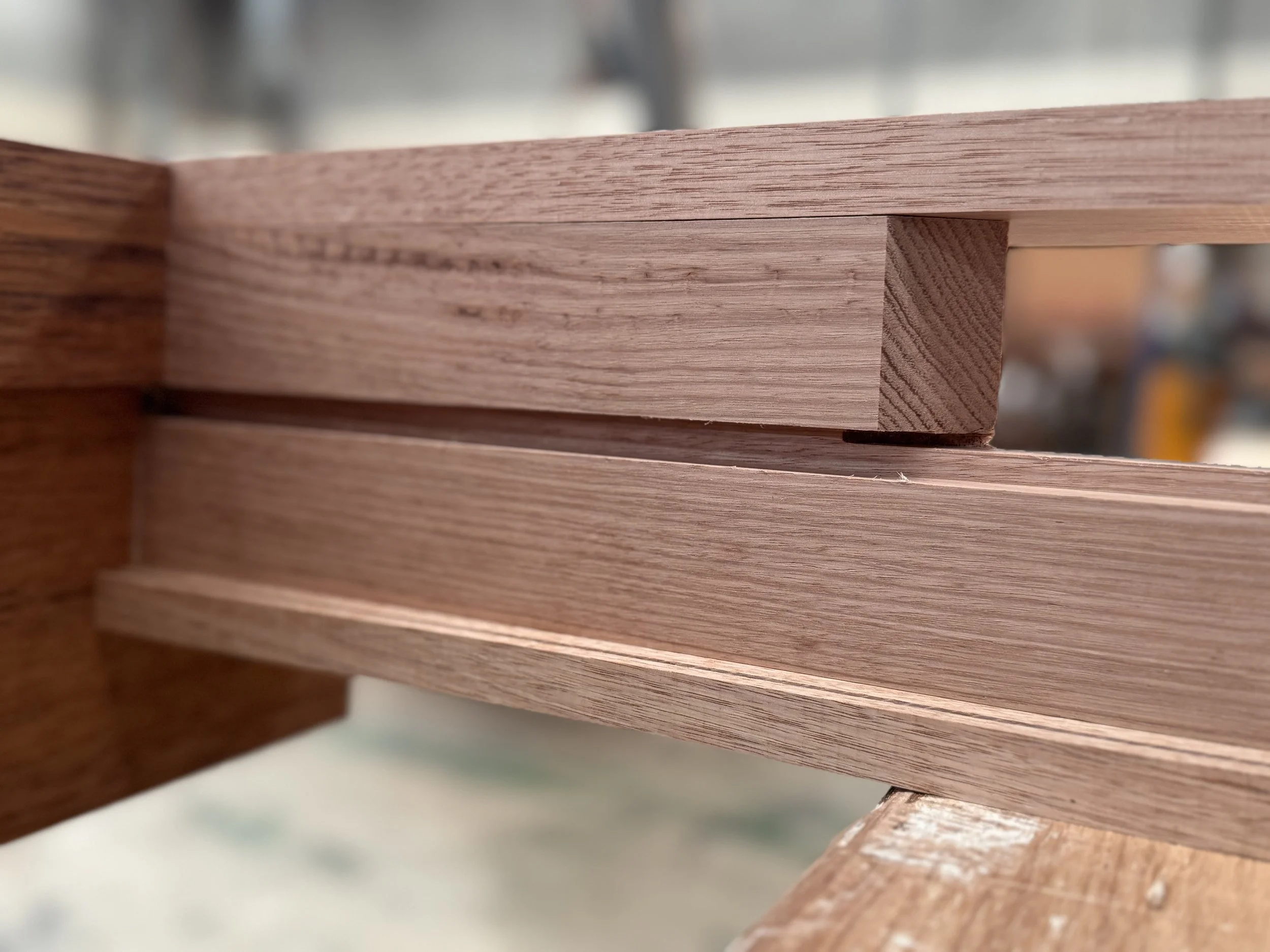 Close-up of stacked wooden pieces, showing the detailed grain and construction.