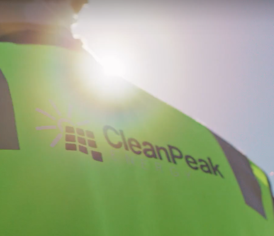 Close-up of CleanPeak Energy's logo on a green product package with the word 'CleanPeak' and a sun icon.